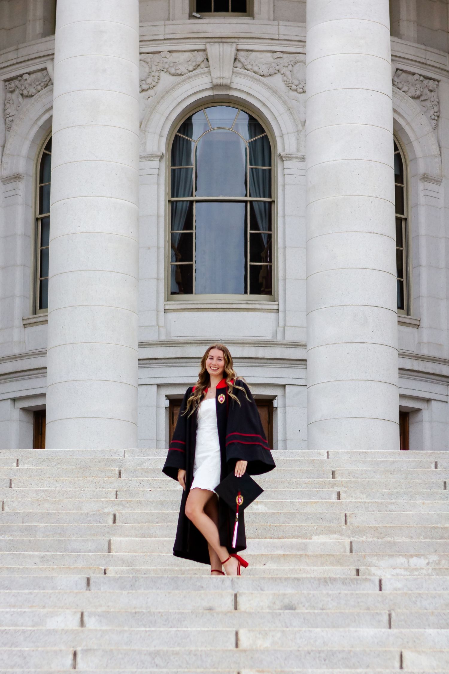 Graduation photos on the grand white marble steps of a government building.