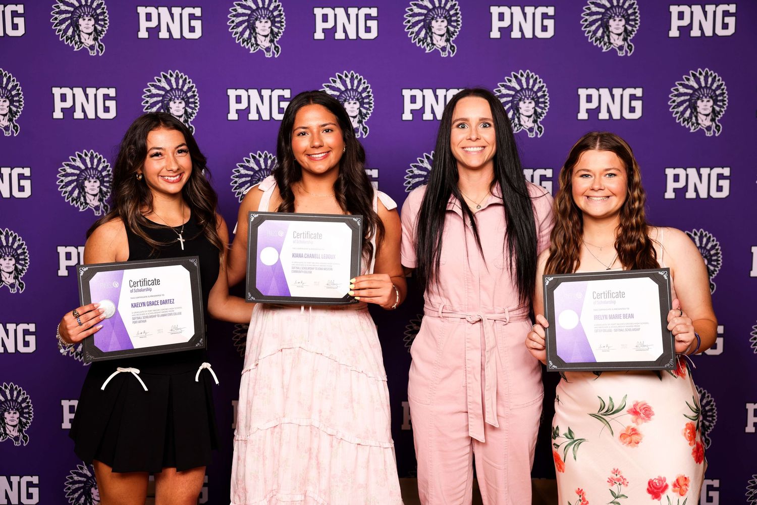 A group of people posing with certificates against a purple backdrop with PNG logos.