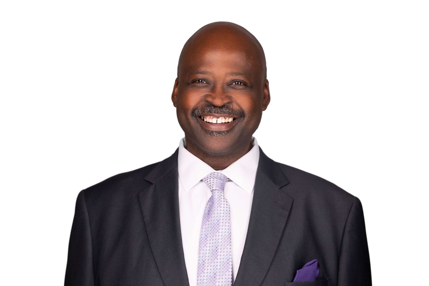 Professional portrait of person in formal business attire with purple pocket square.