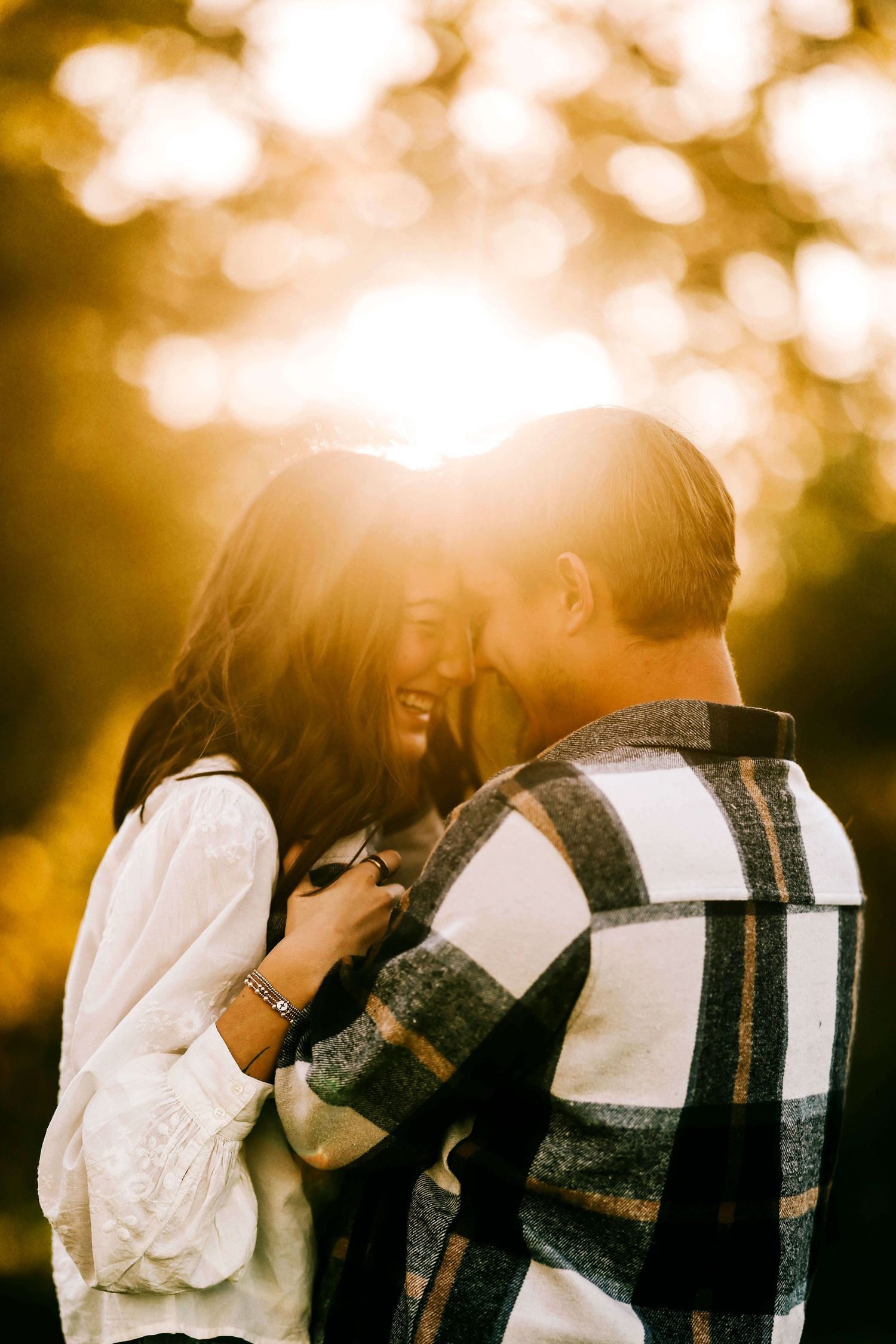 Romantic couple sharing an intimate moment in golden sunset light.