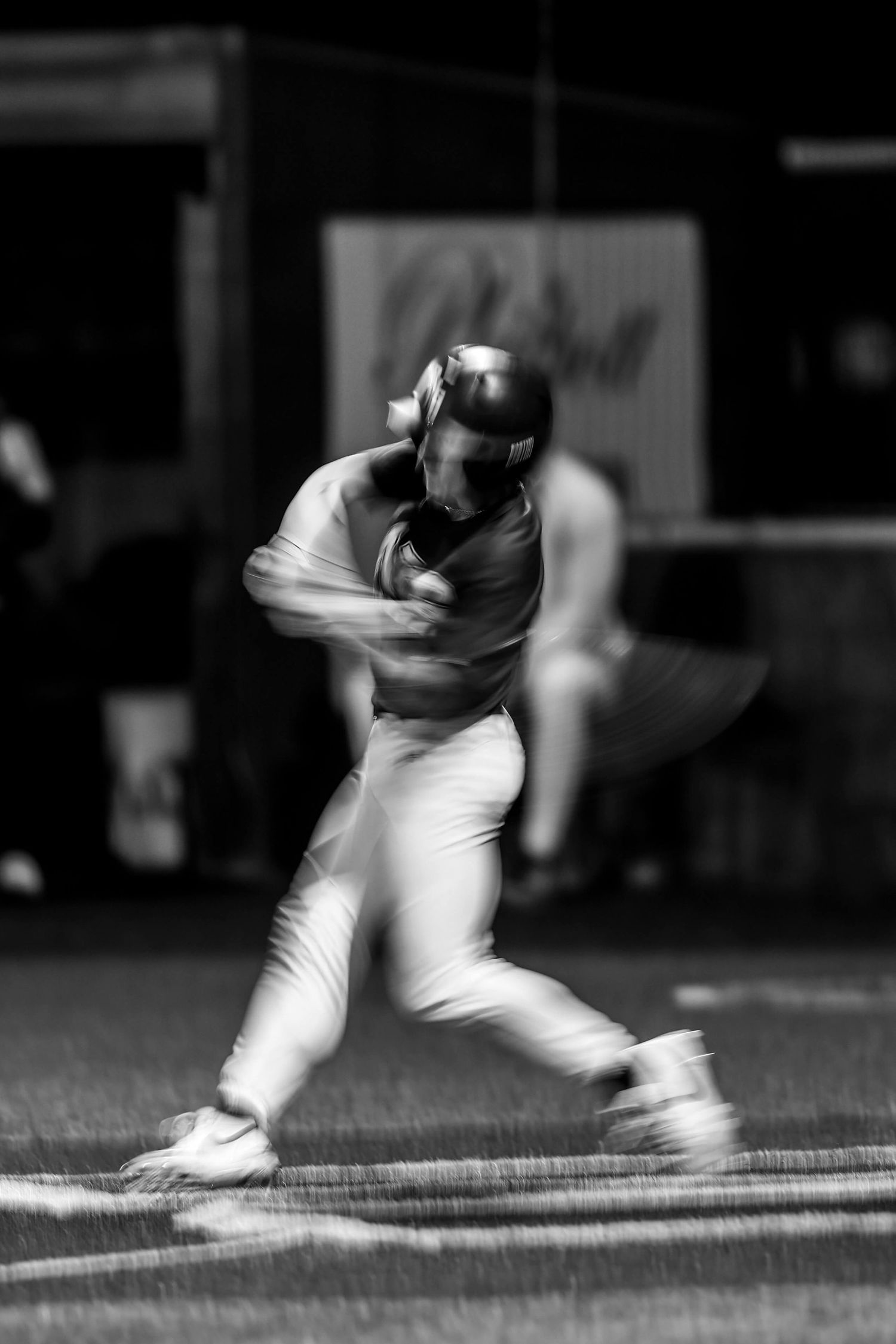 Motion blur sequence shows baseball player sliding into base during game.