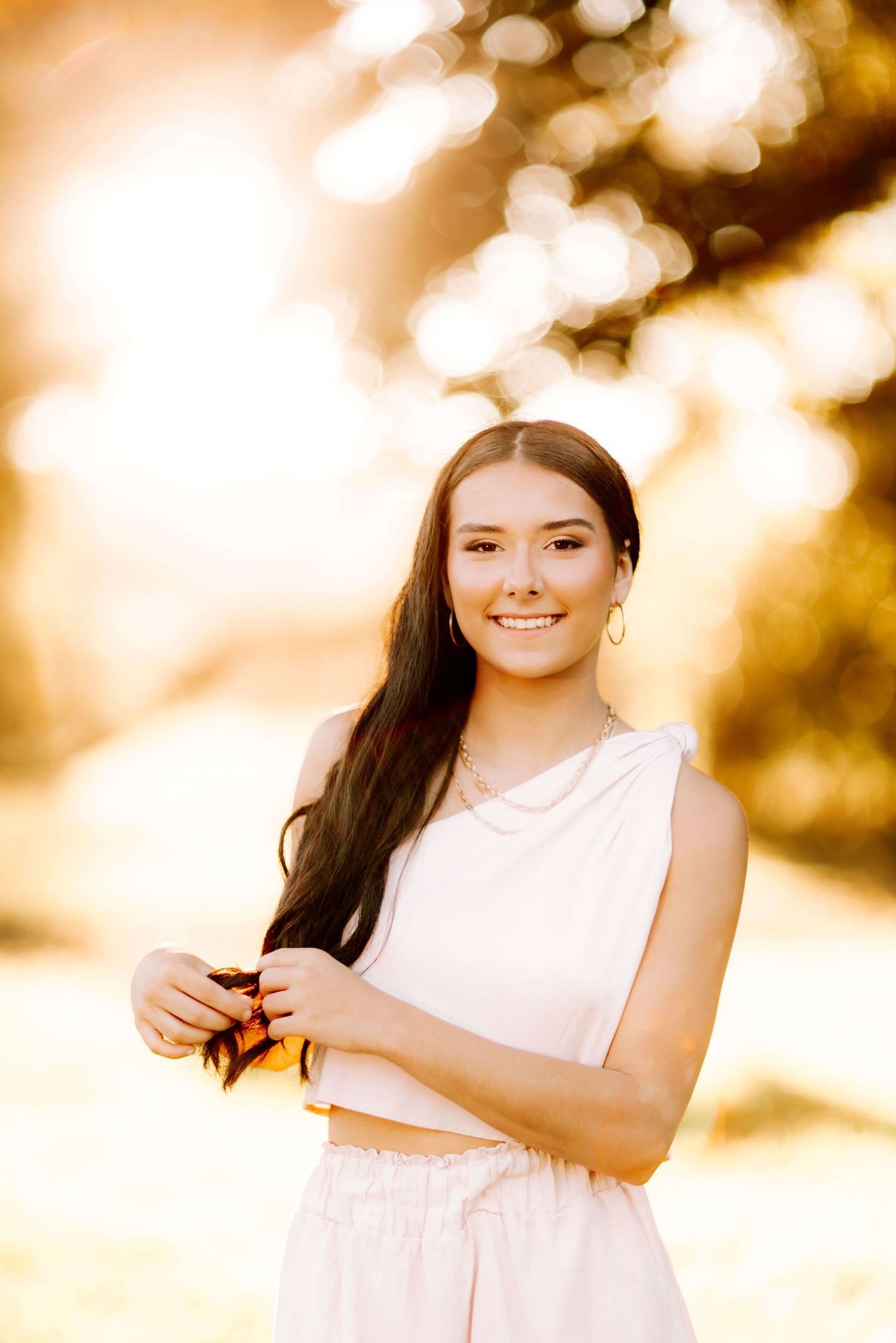 A golden hour portrait session with warm bokeh lighting effects.