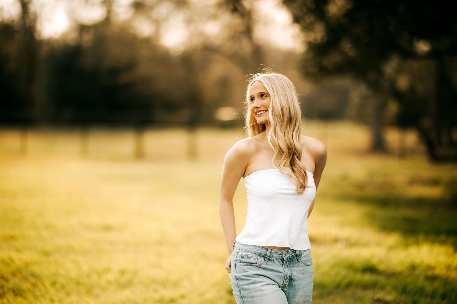 Casual summer portraits in golden sunlit field.