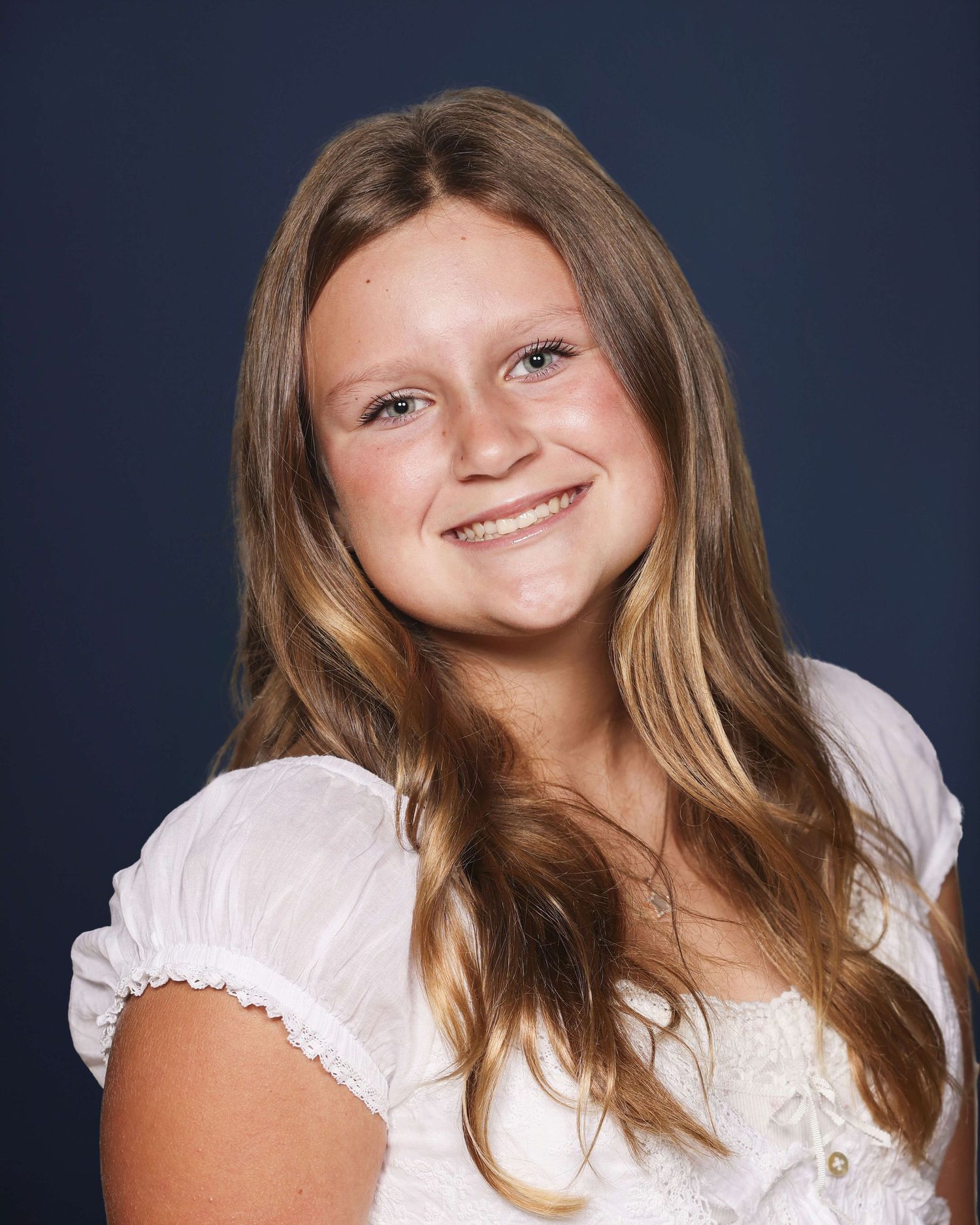 Portrait series showing someone with long brown hair wearing a white top against dark blue background.