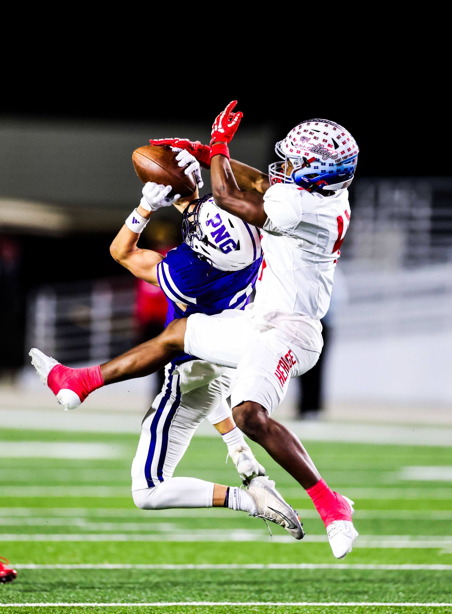 Dynamic action shot of football players diving and tackling during gameplay.