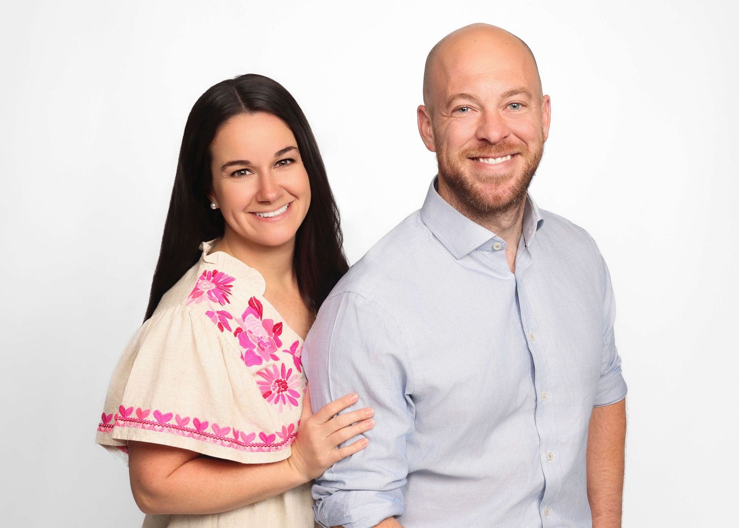 Professional studio portraits of a couple in casual attire against white background showing different poses and expressions.