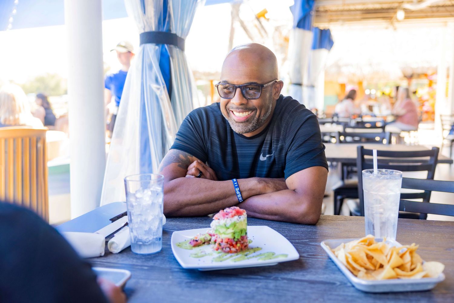 A series of photos showing a dining experience at a restaurant with plates of food and drinks on a table.