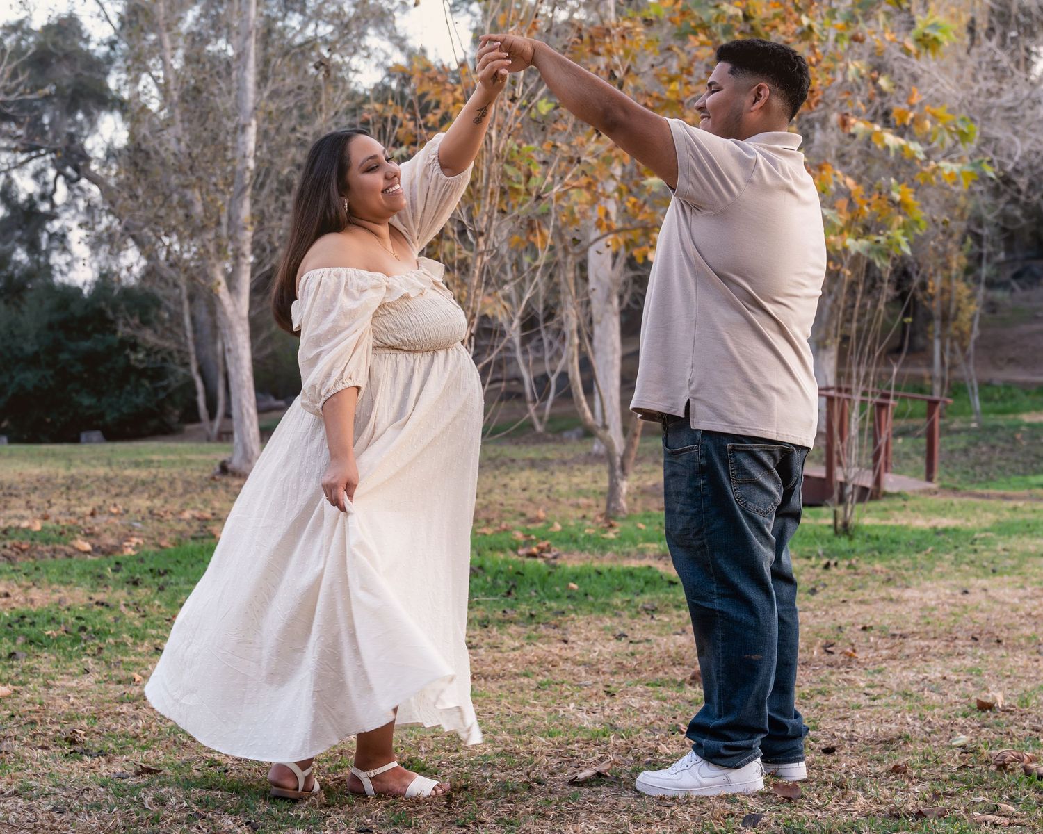Romantic dance moves captured during an outdoor couple's photoshoot in nature.