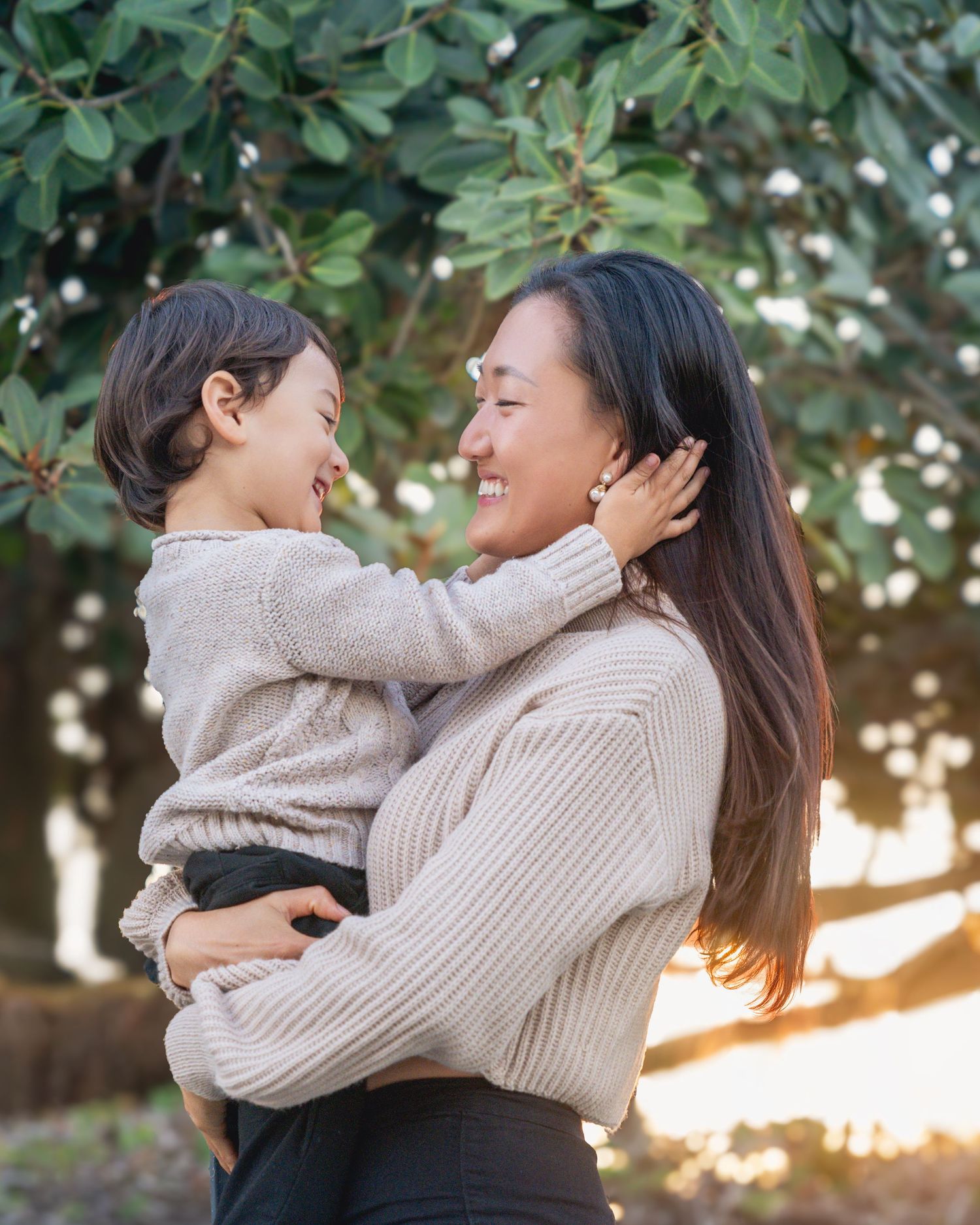 Tender moment between two people embracing outdoors during golden hour.
