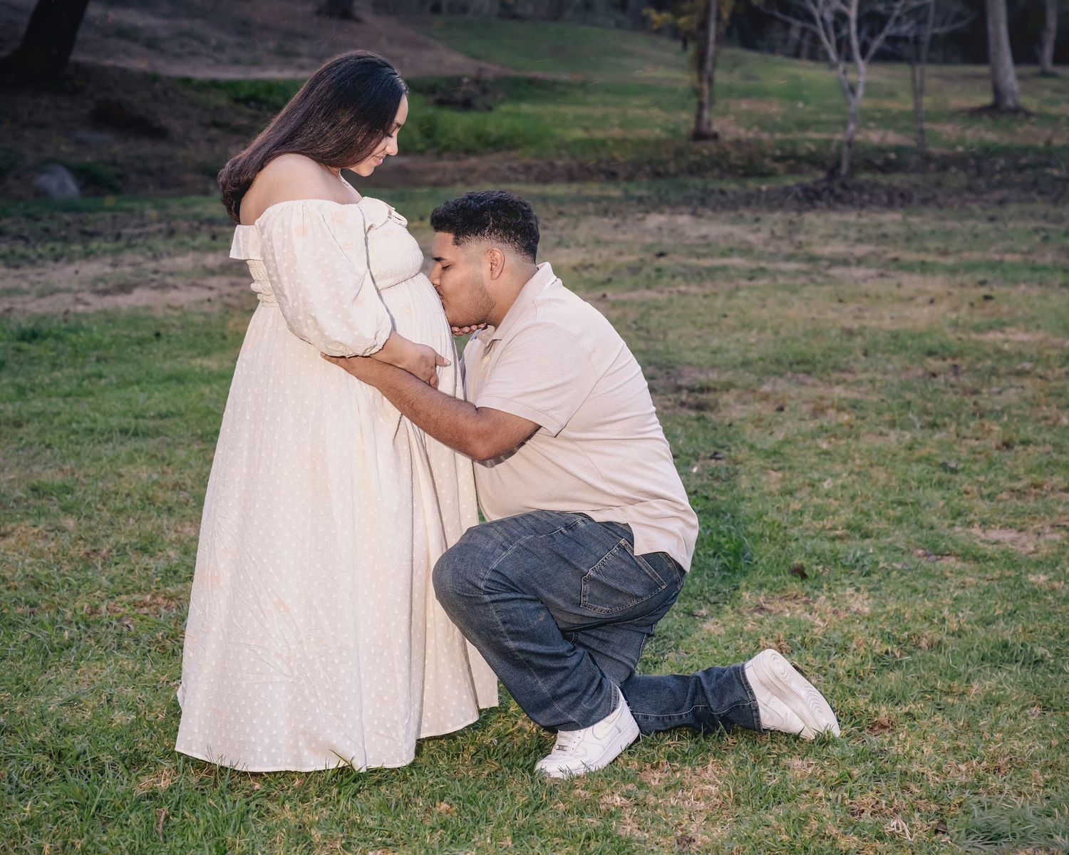 Romantic outdoor photoshoot featuring coordinated outfits against a natural backdrop.