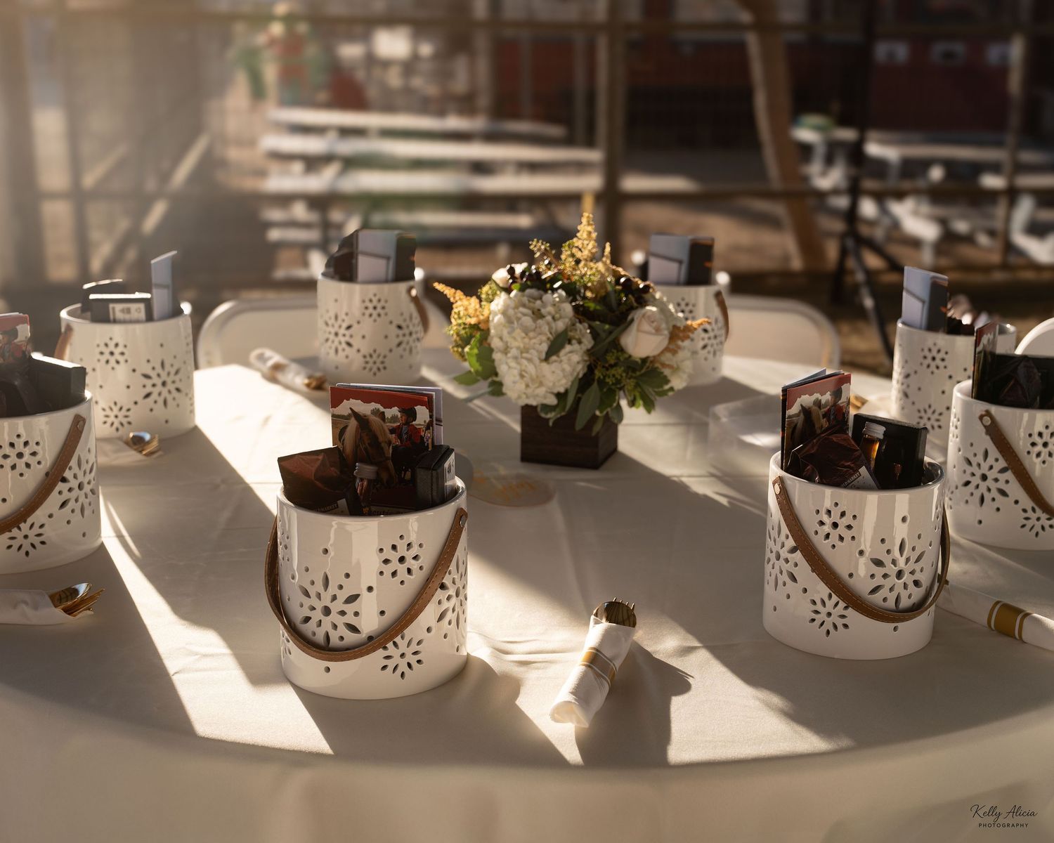 White ceramic lanterns with cutout patterns casting shadows on a sunlit table.