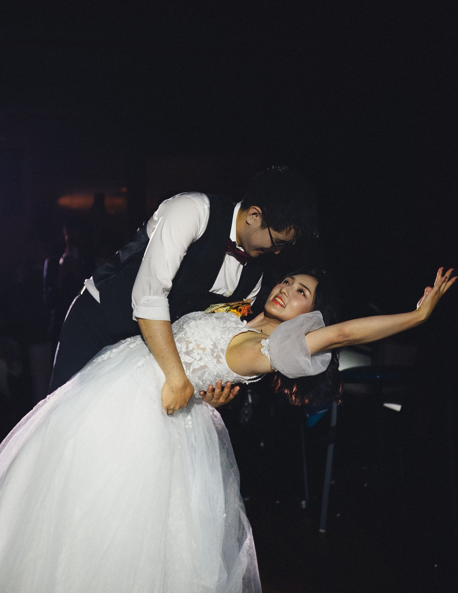 Bride and groom sharing a joyful dance during an intimate wedding reception.