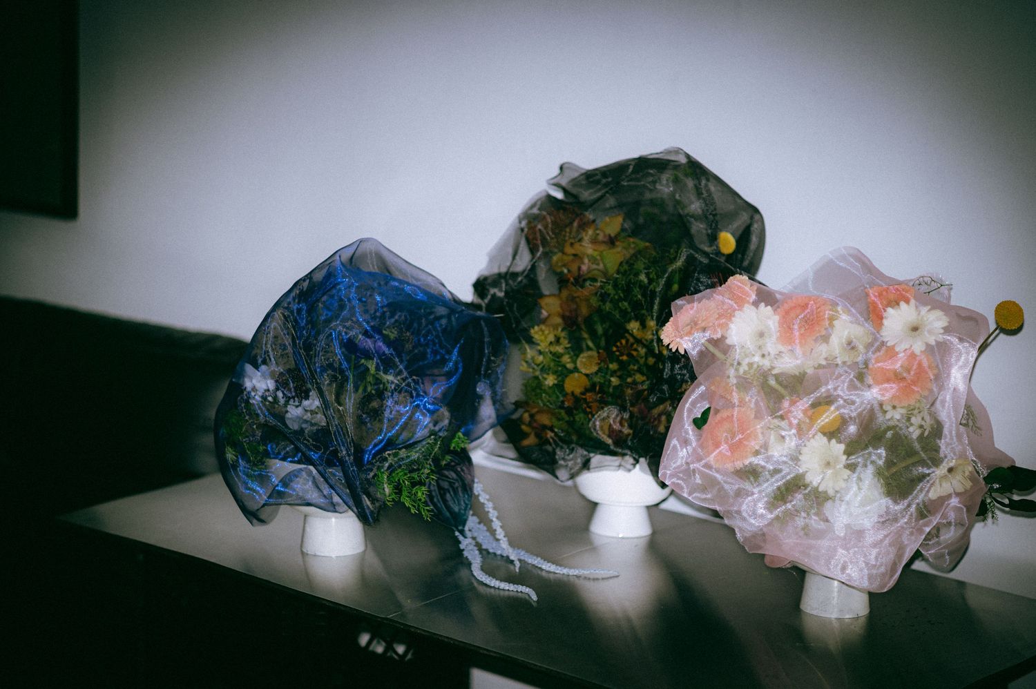 three floral arrangement designs covered with fabrics