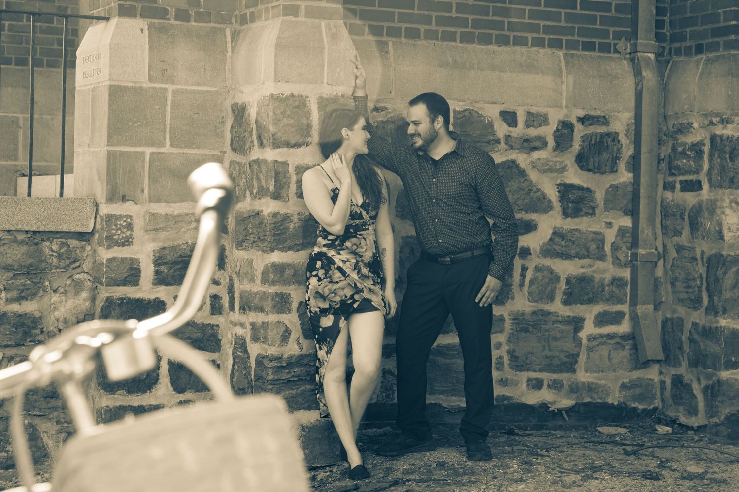 Vintage-style sepia photos of people posing playfully along stone wall.
