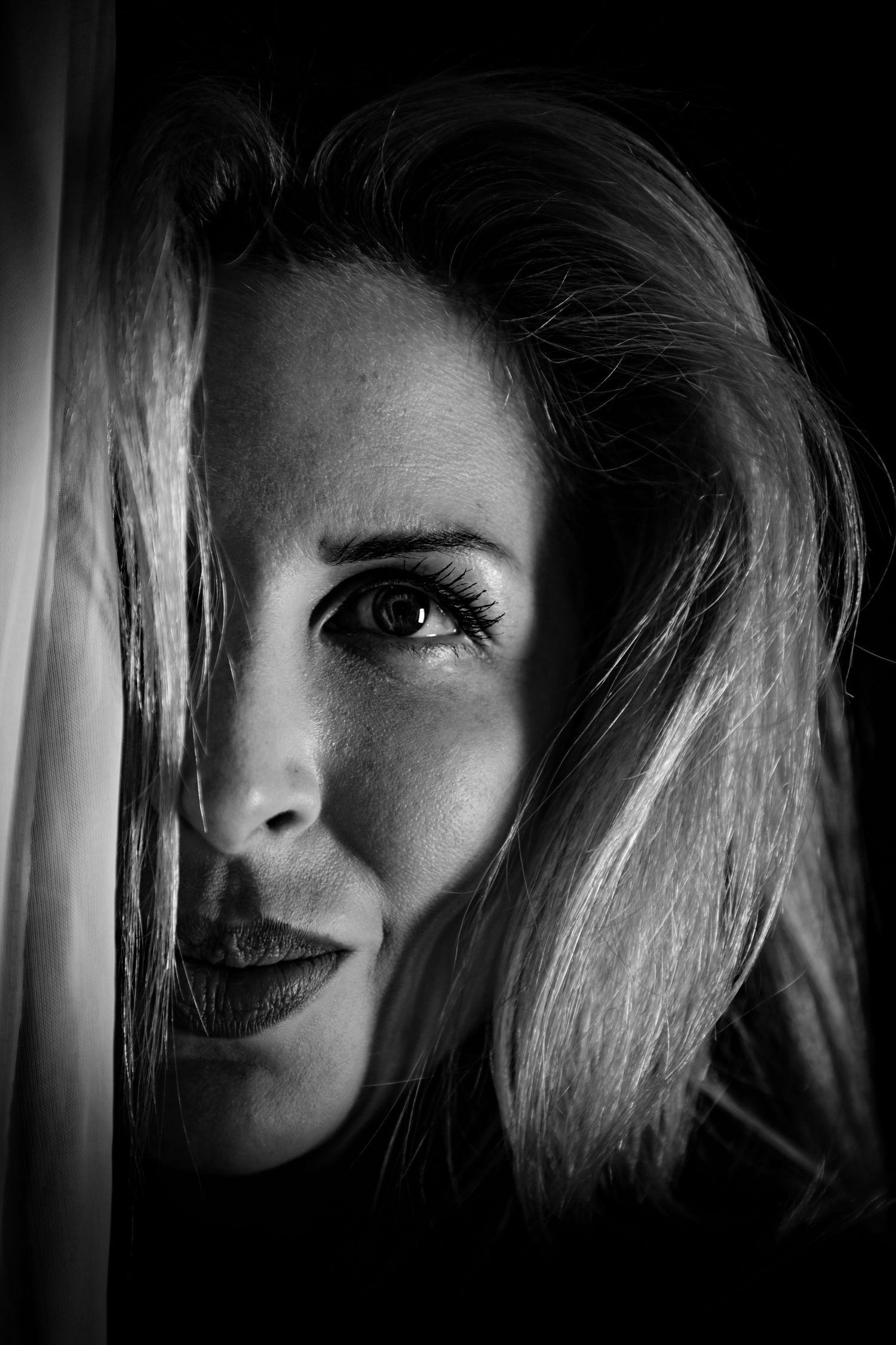 Film noir style black and white portrait series with dramatic shadows and lighting.