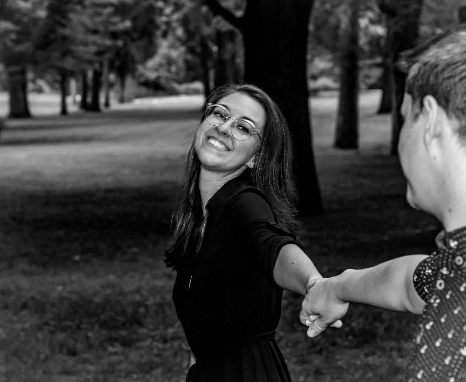 Candid black and white portraits showing joyful laughter outdoors.