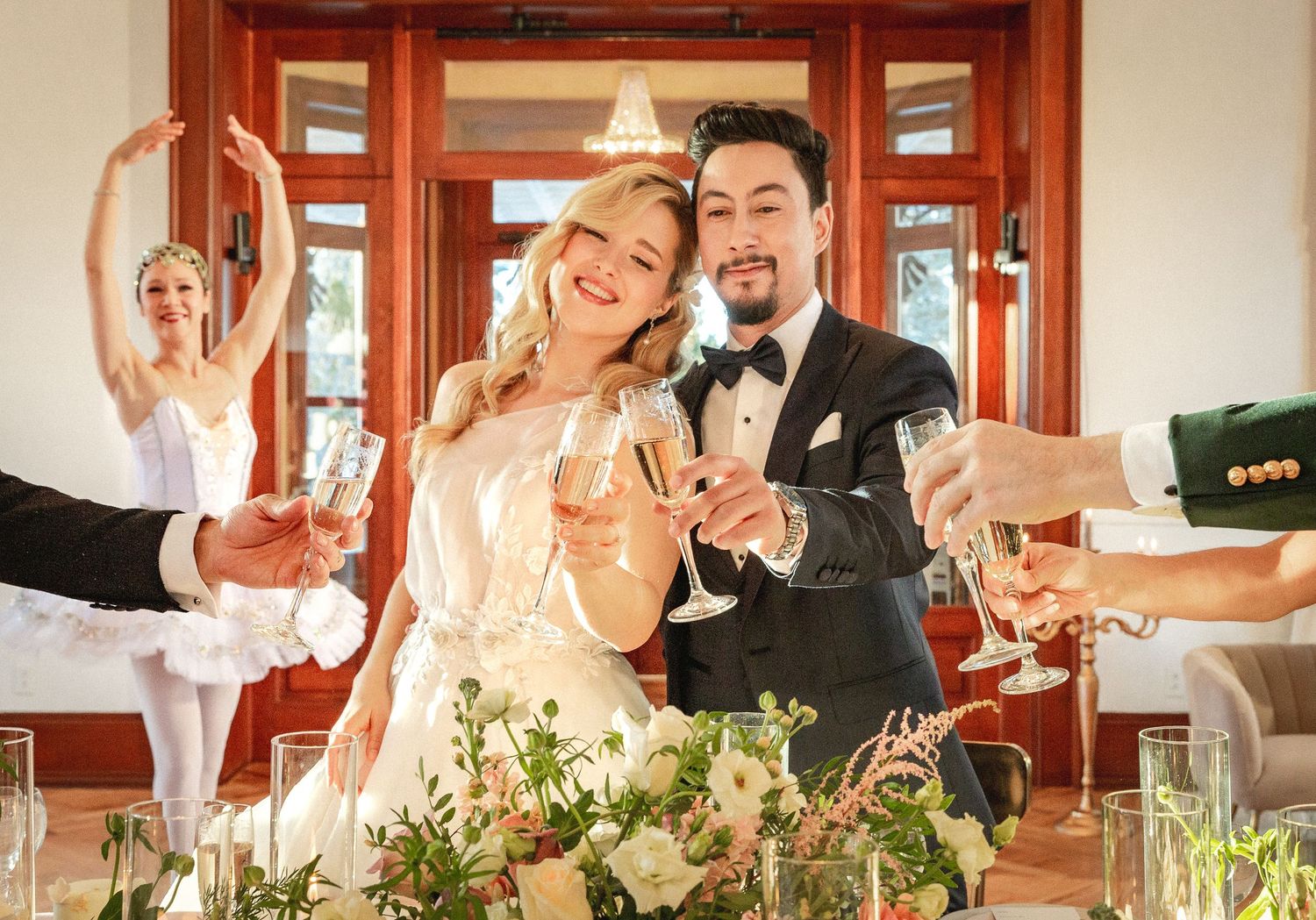 Wedding celebration scene with champagne toasts and floral decorations in an elegant indoor setting.