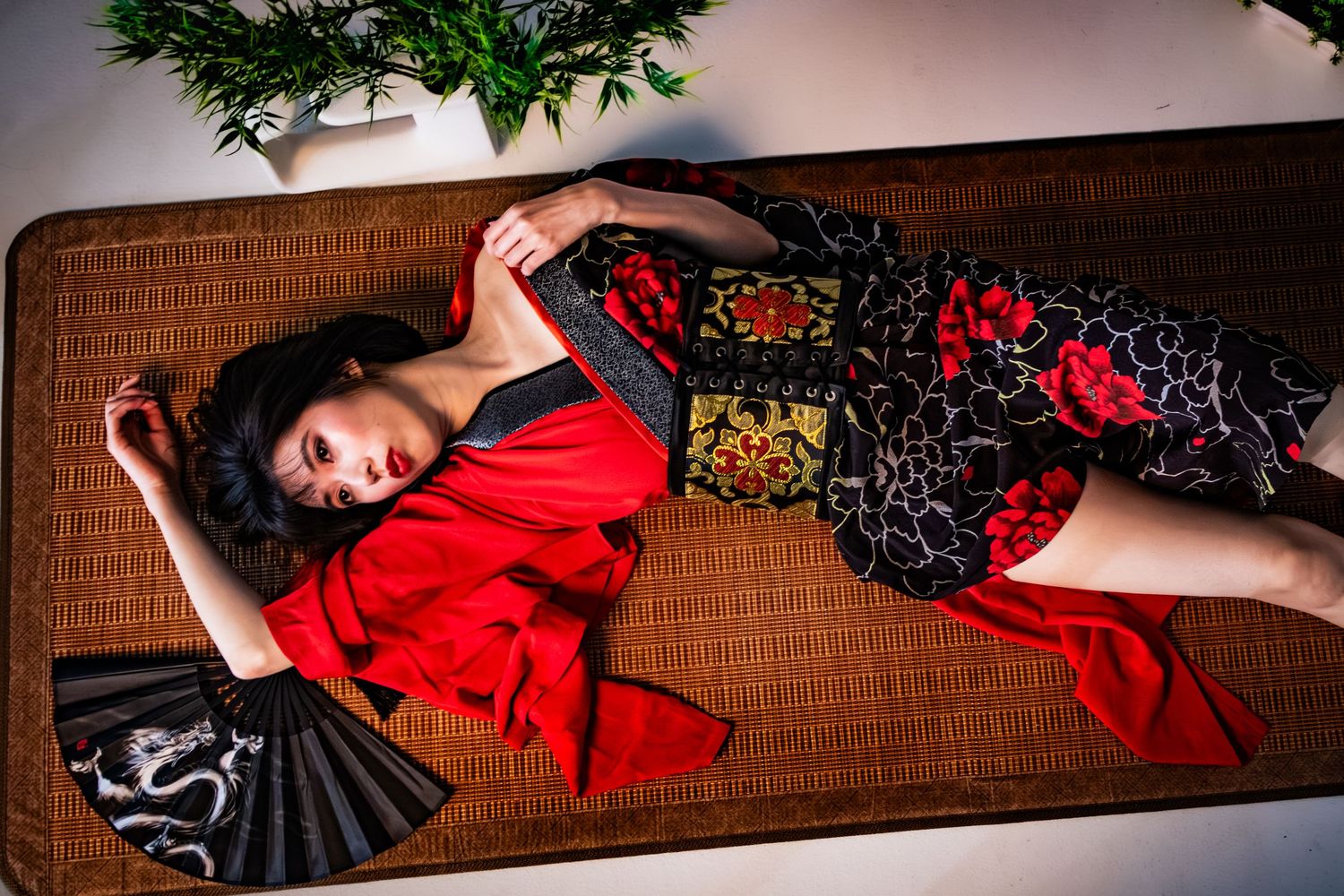Artistic photo series showing red kimono on wooden floor with dramatic lighting and poses.