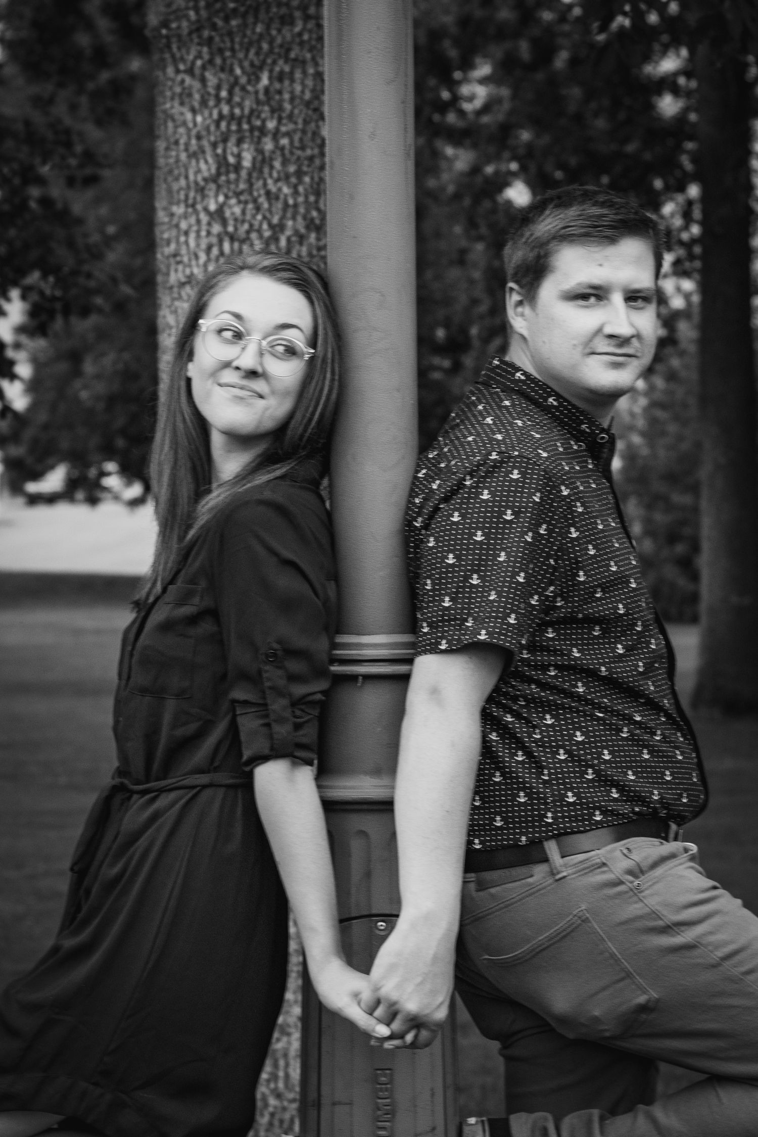 Artistic black and white portrait session against architectural columns.