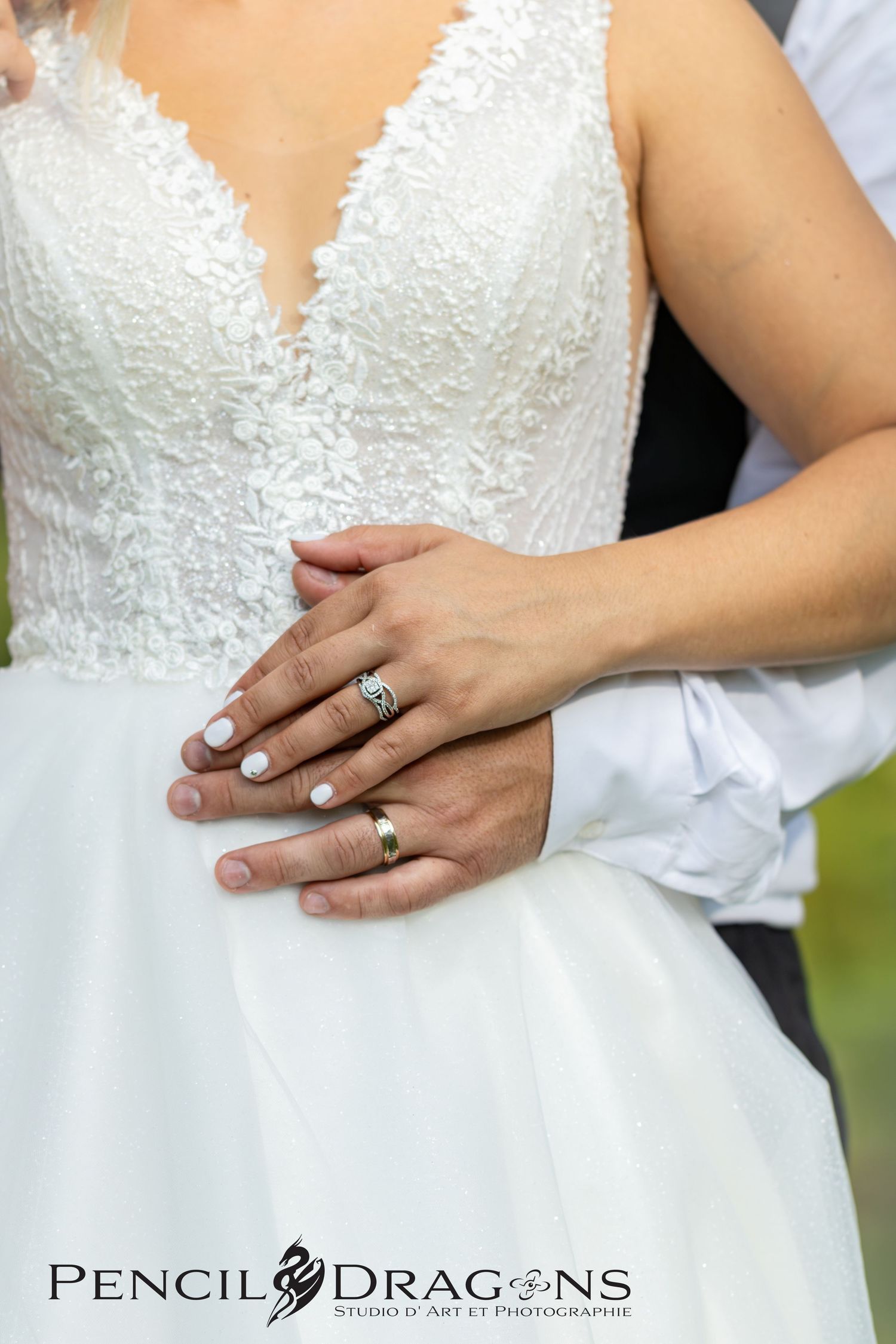 Close-up sequence of a bride's hand showing off her wedding ring and lace dress details.