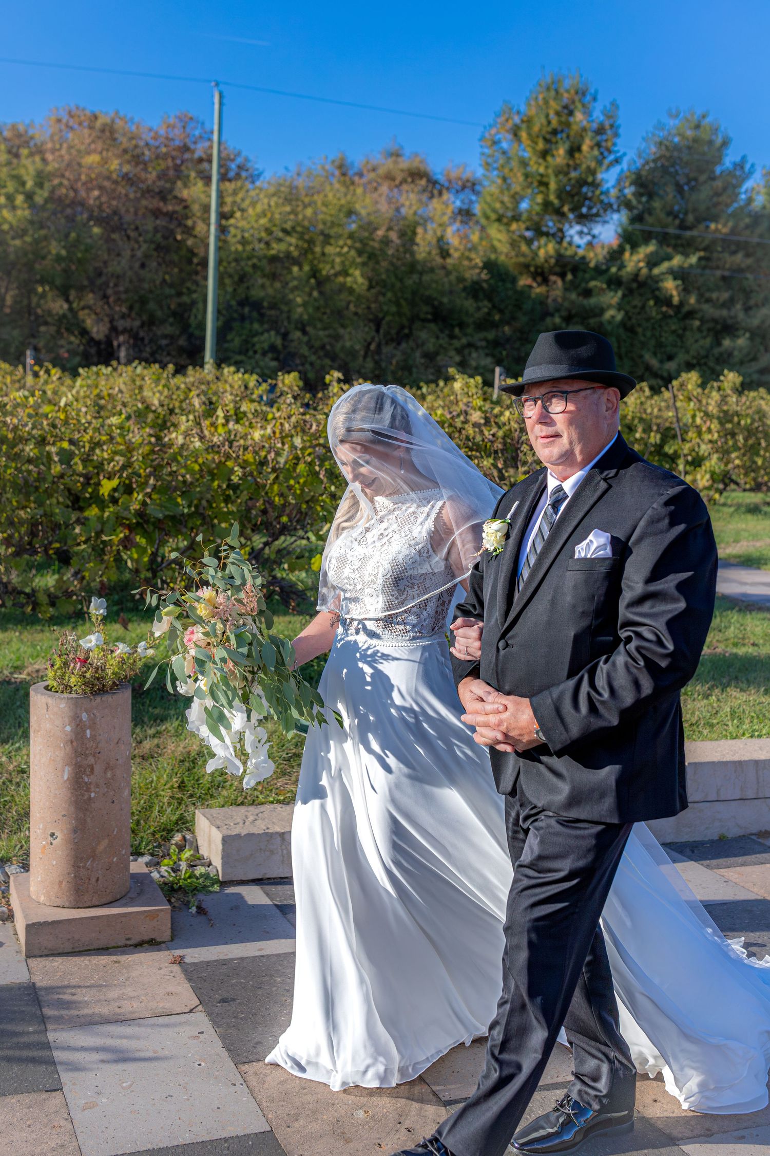 Dancing couple in formal attire enjoying a celebration outdoors.