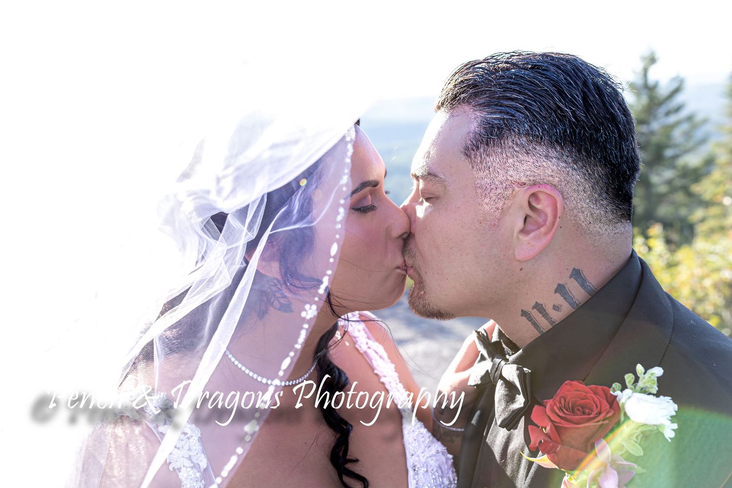 Romantic wedding couple shares intimate moments under sunlit trees.