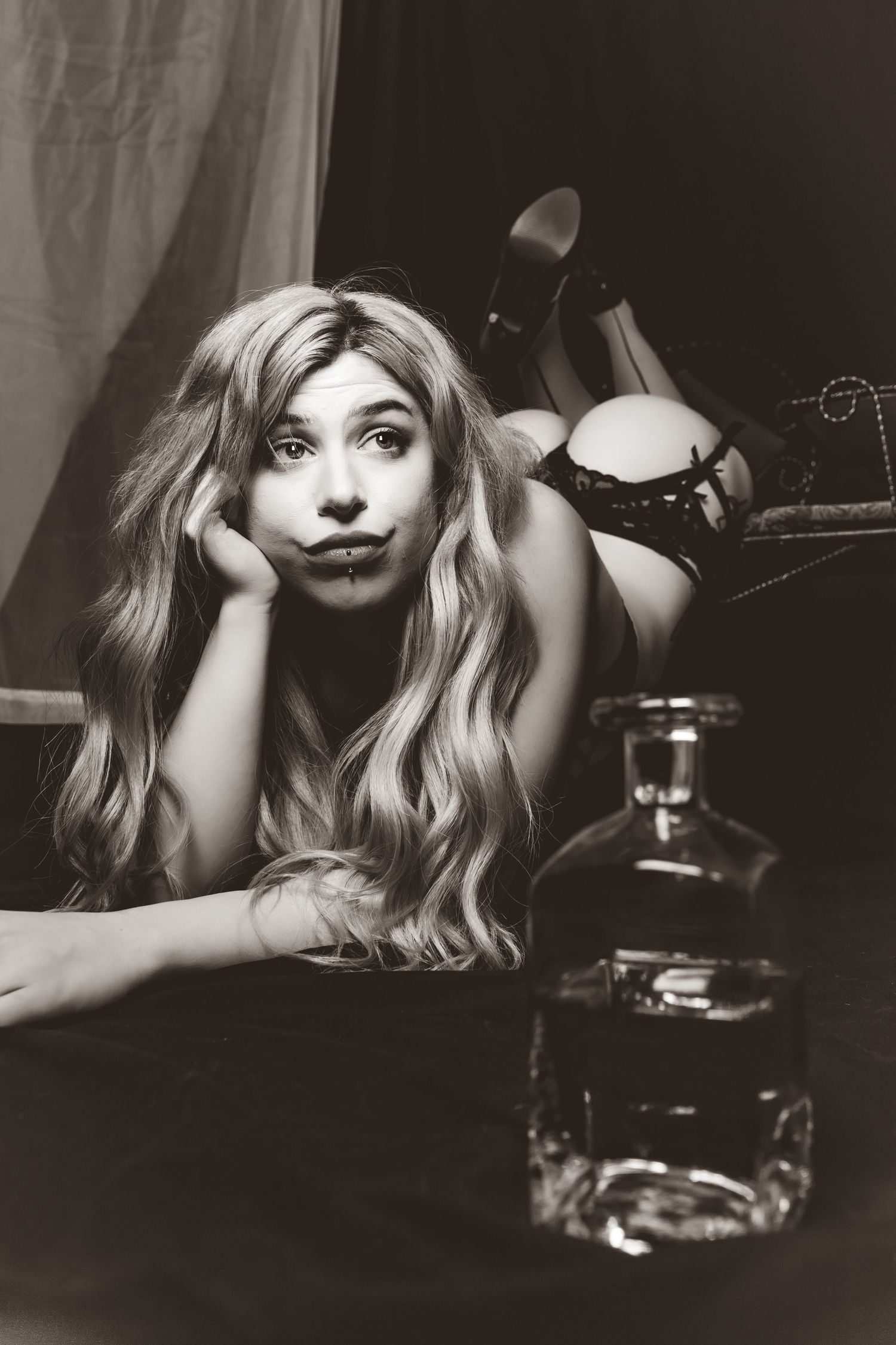 Dramatic black and white boudoir photography series with vintage styling elements.