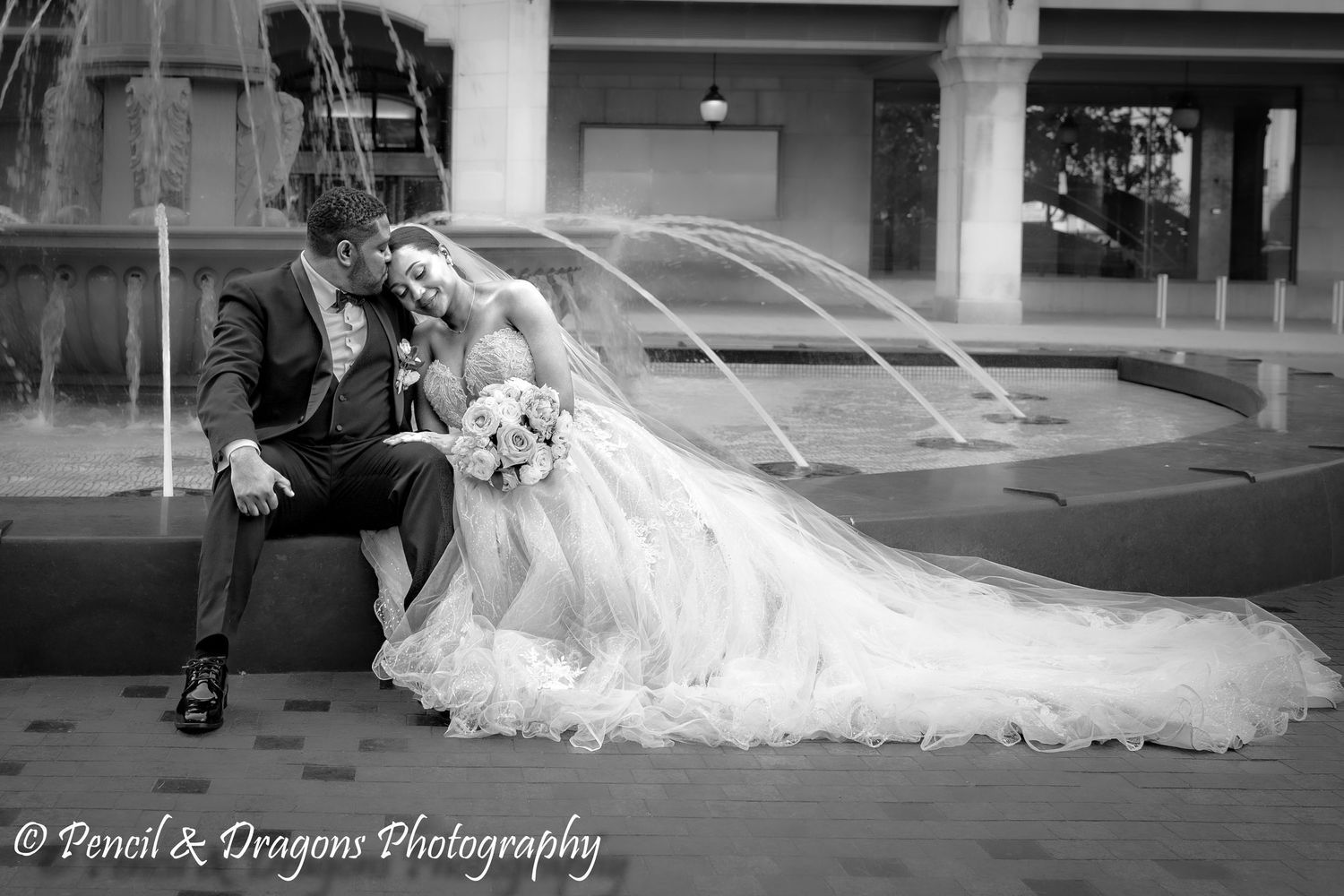 Black and white panoramic sequence showing the dramatic sweep of a wedding dress train.