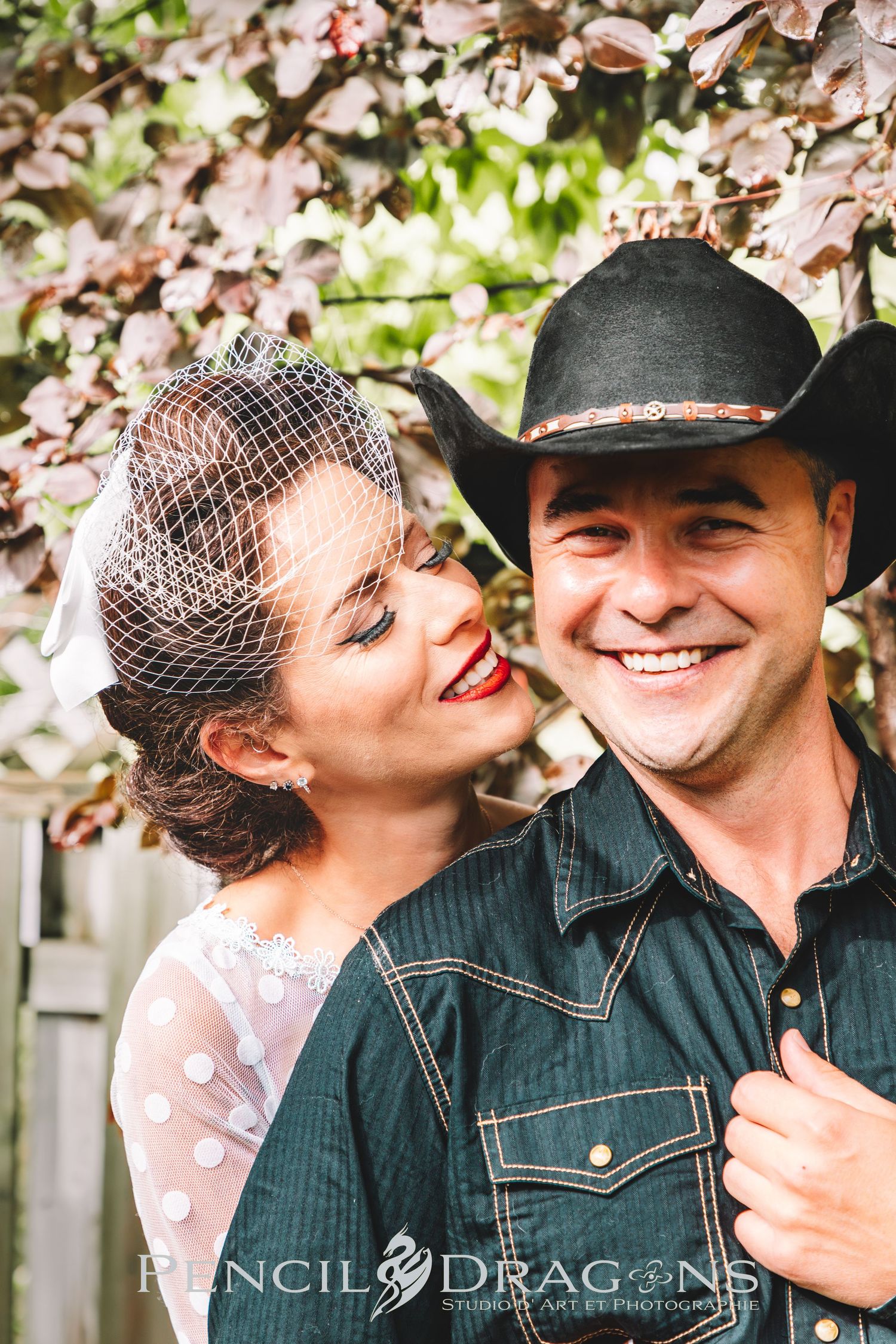 A romantic wedding photo featuring western style attire and a vintage bridal gown.