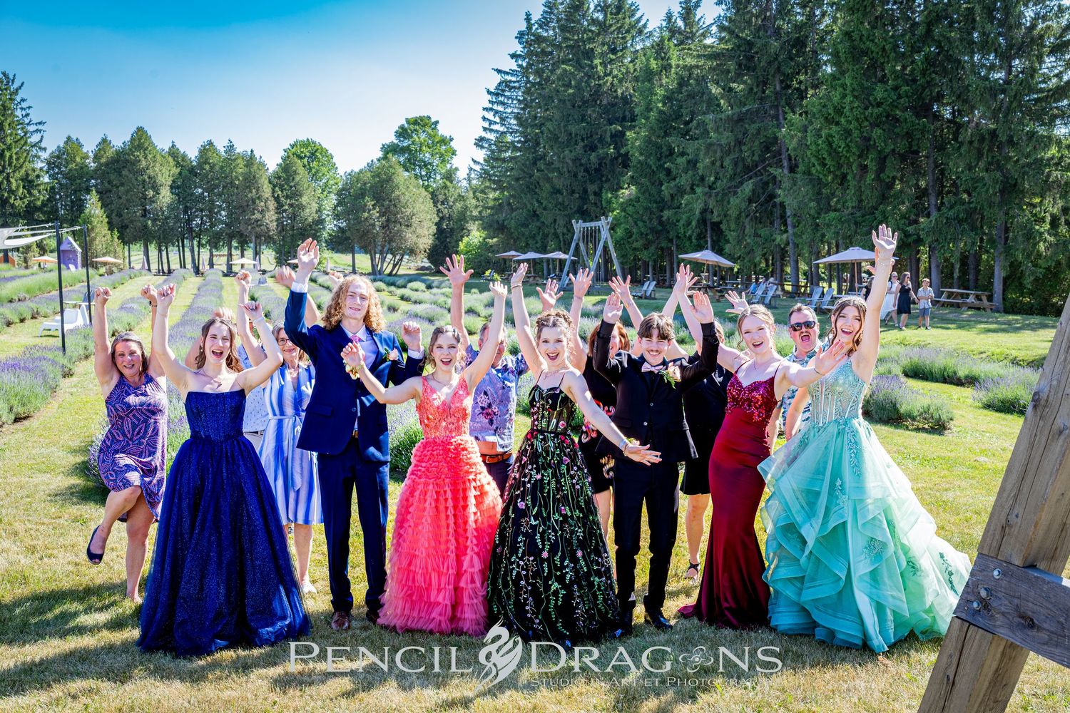 Celebration group photo series with people in formal attire gathered outdoors near pine trees.