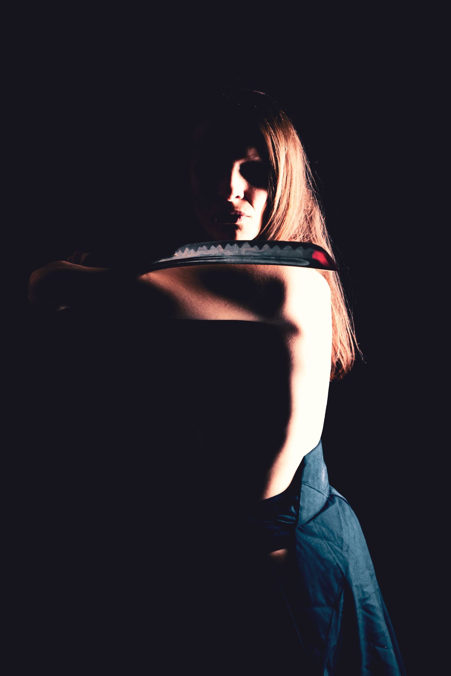 Minimalist silhouette photography series with dramatic side lighting against dark background.