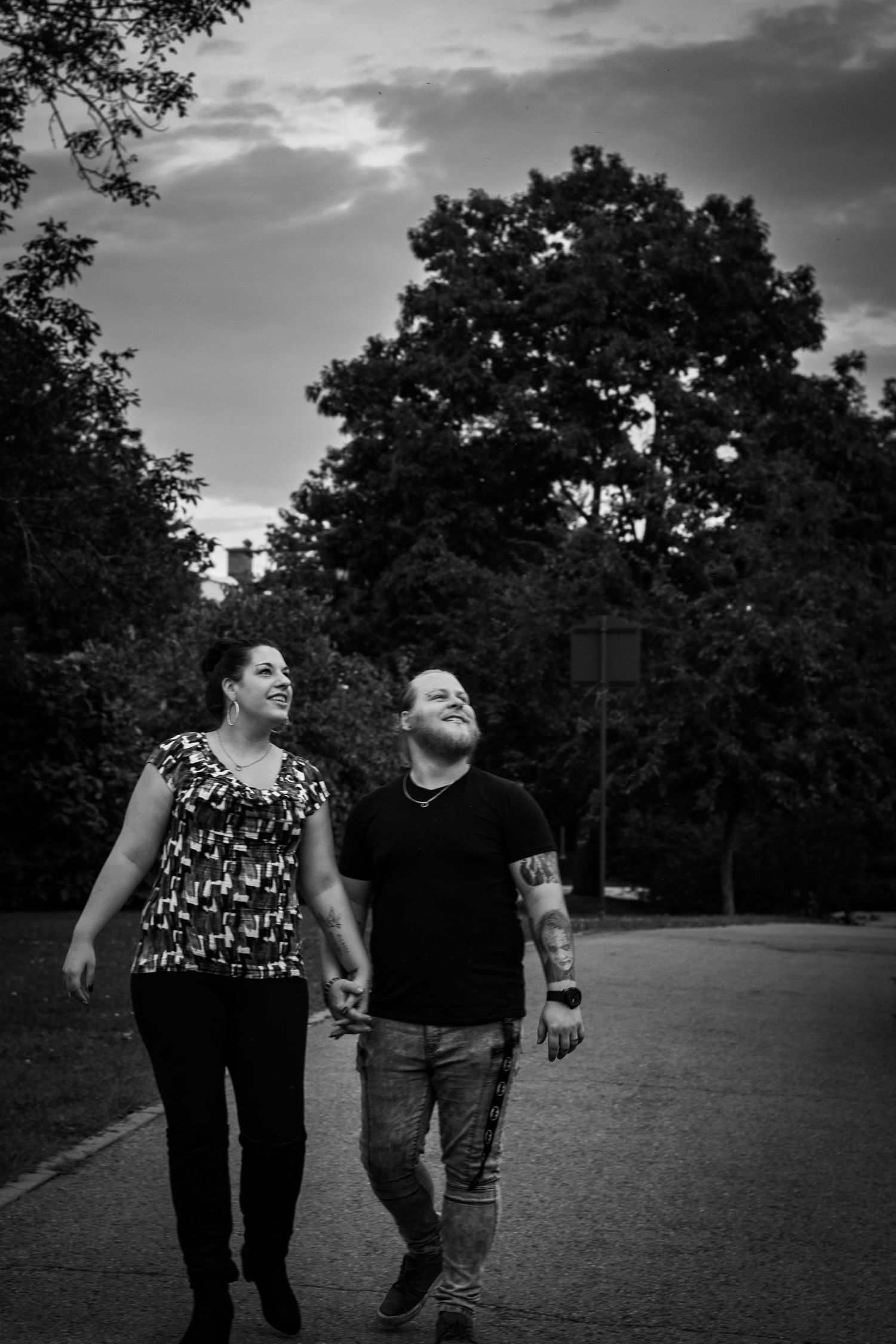 Black and white engagement photos captured in a scenic park setting.