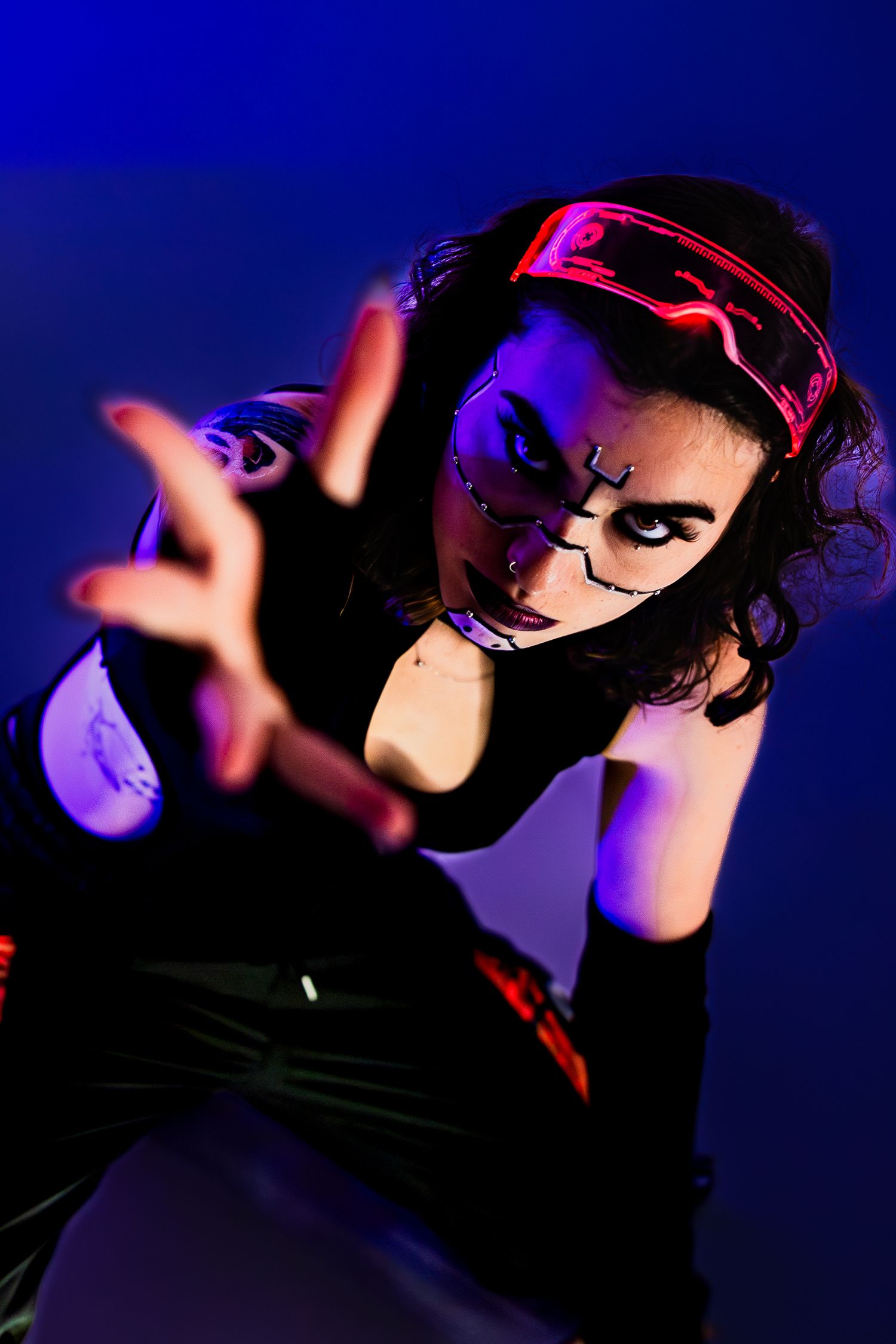Dramatic blue and pink lit portrait series with artistic silhouettes and gestures.