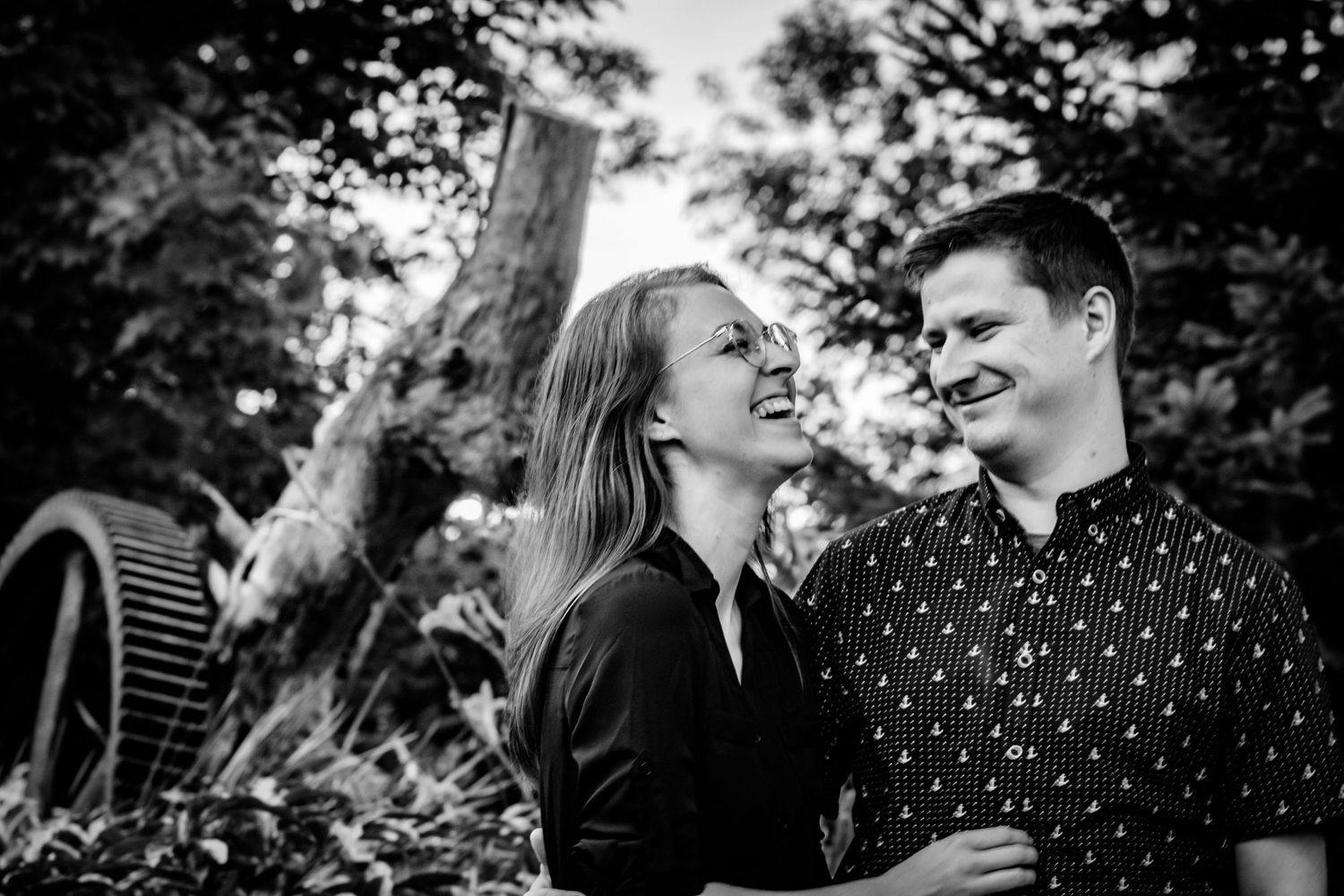 Black and white portrait session showing genuine laughter and connection.