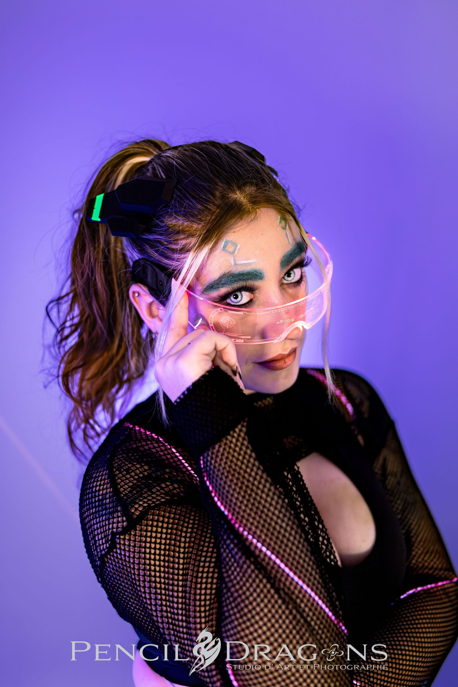 Artistic portrait series with purple lighting and dramatic makeup against dark background.