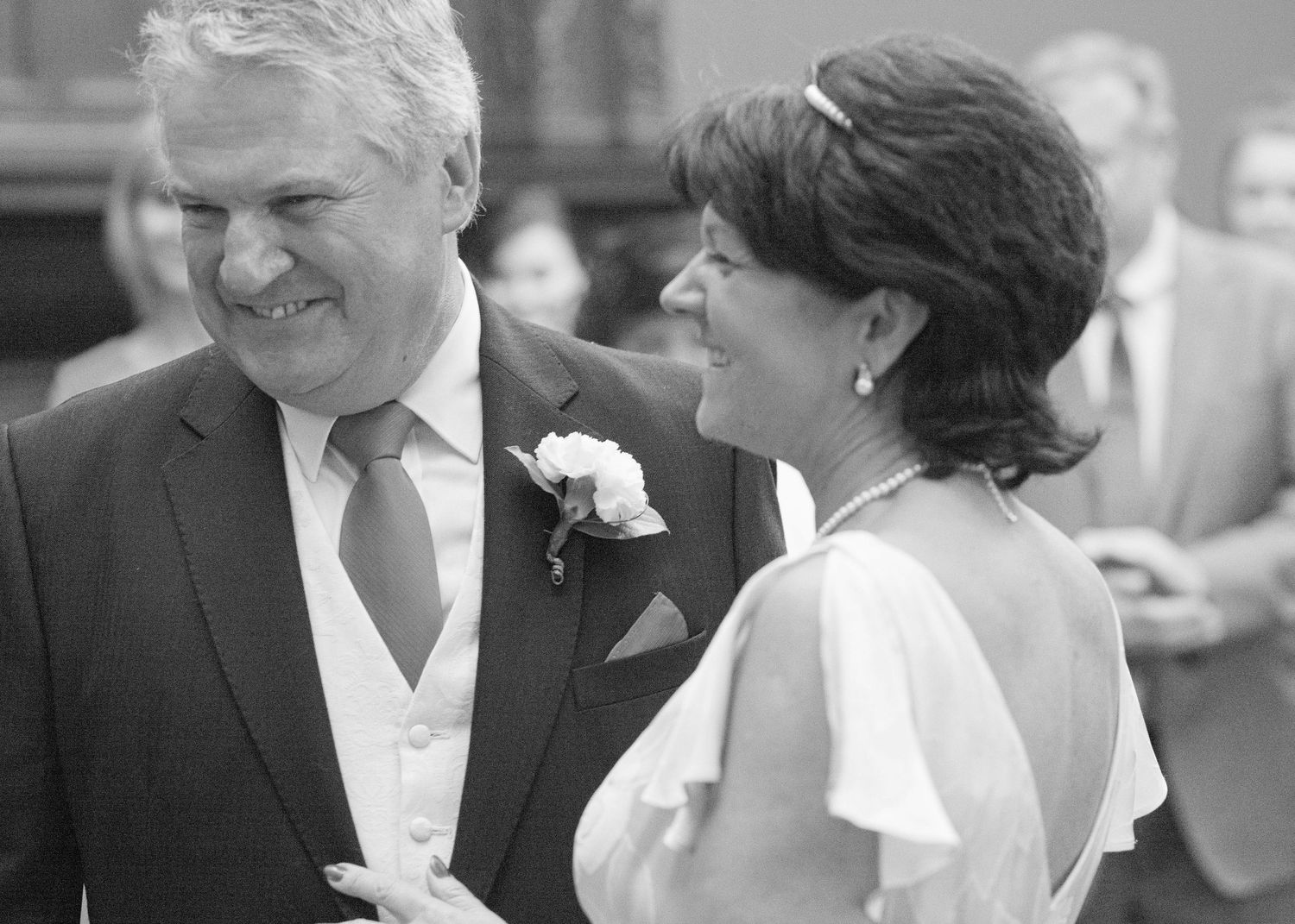 Black and white wedding photos capturing tender moments between newlyweds.