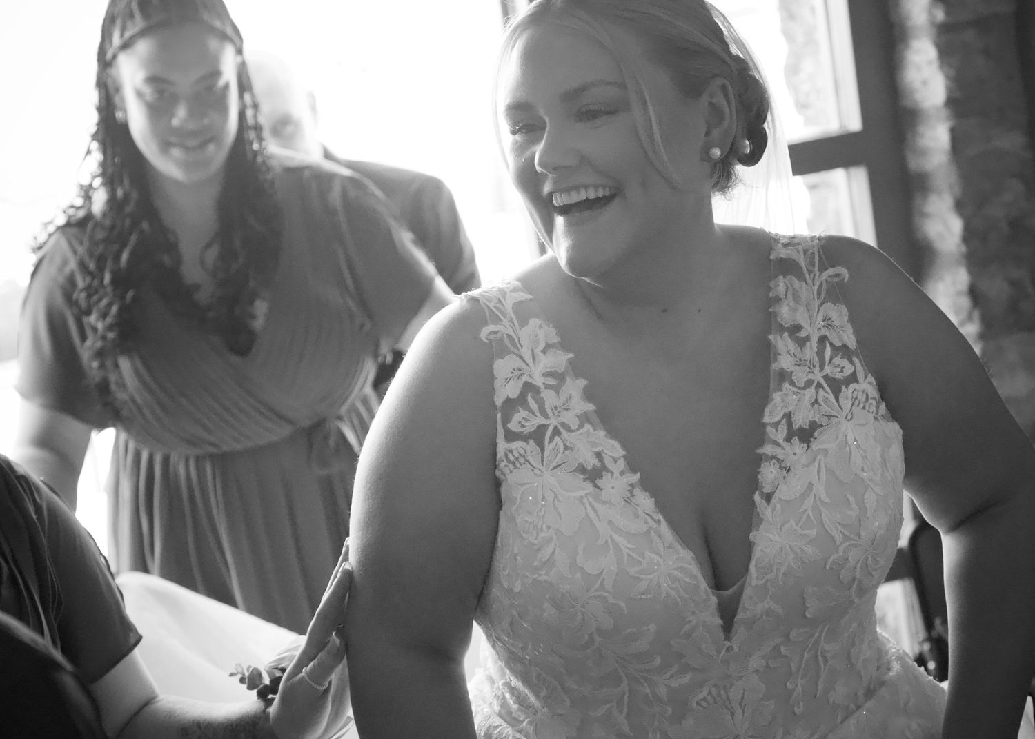 Wedding party members share candid moments during the celebration.
