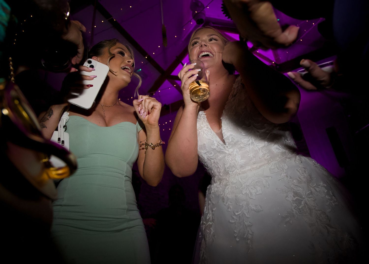 Bride and her friends enjoy dancing at the reception disco with drinks at Folly Farm in Somerset, near Bristol, south west England.