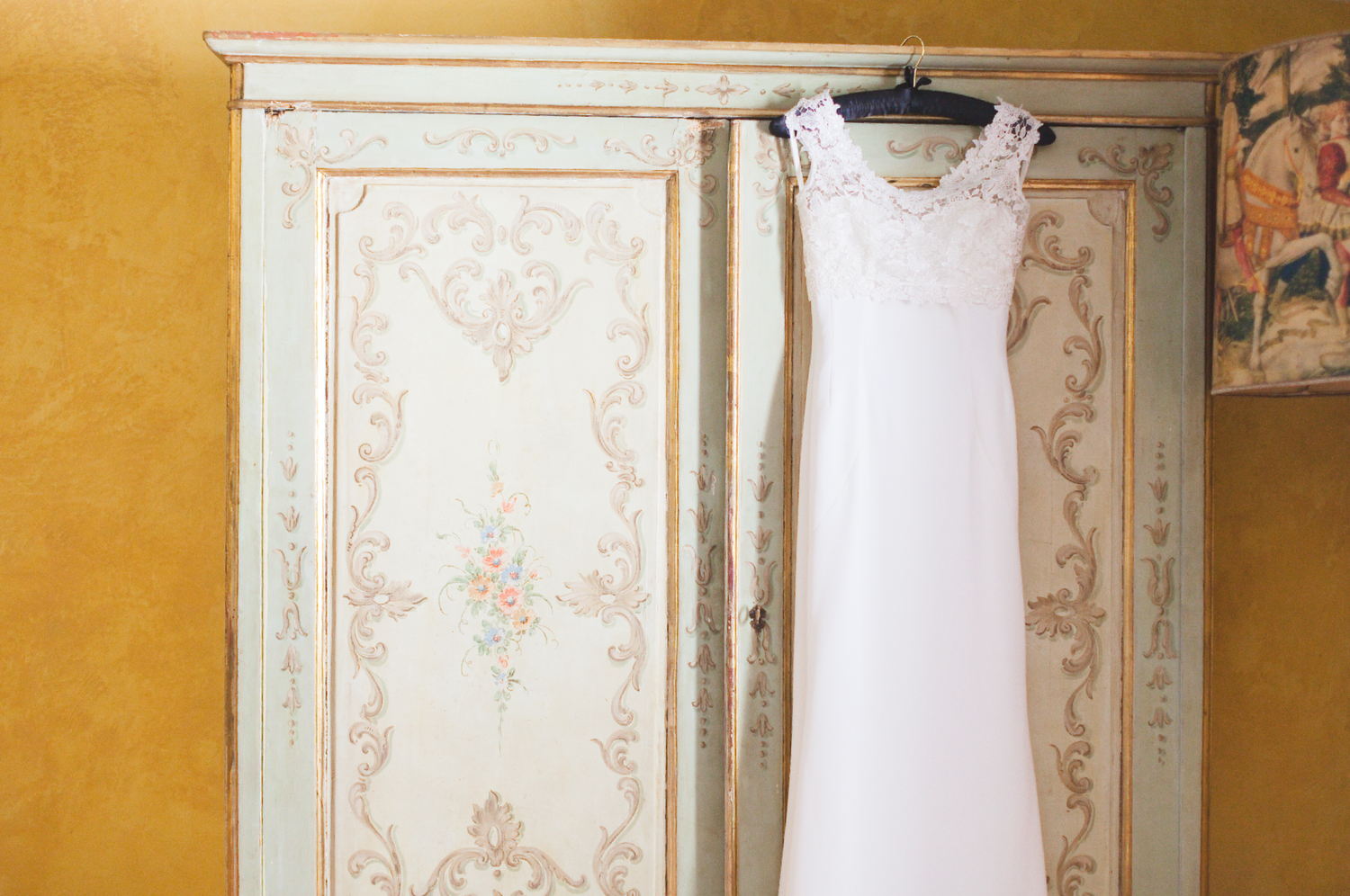 Interior view of room with yellow walls and ornate decorative molding.