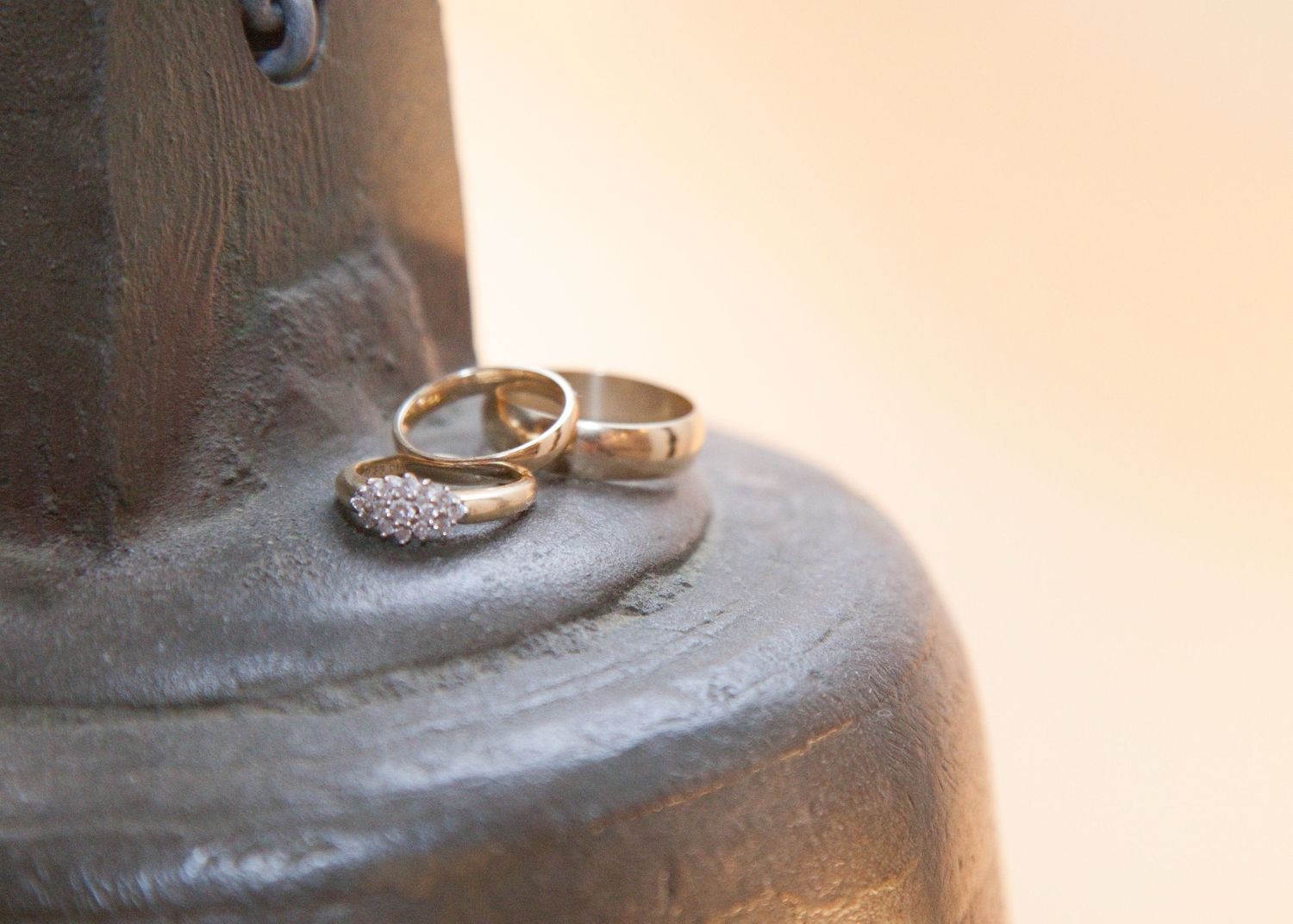 Wedding rings displayed on a textured gray surface.