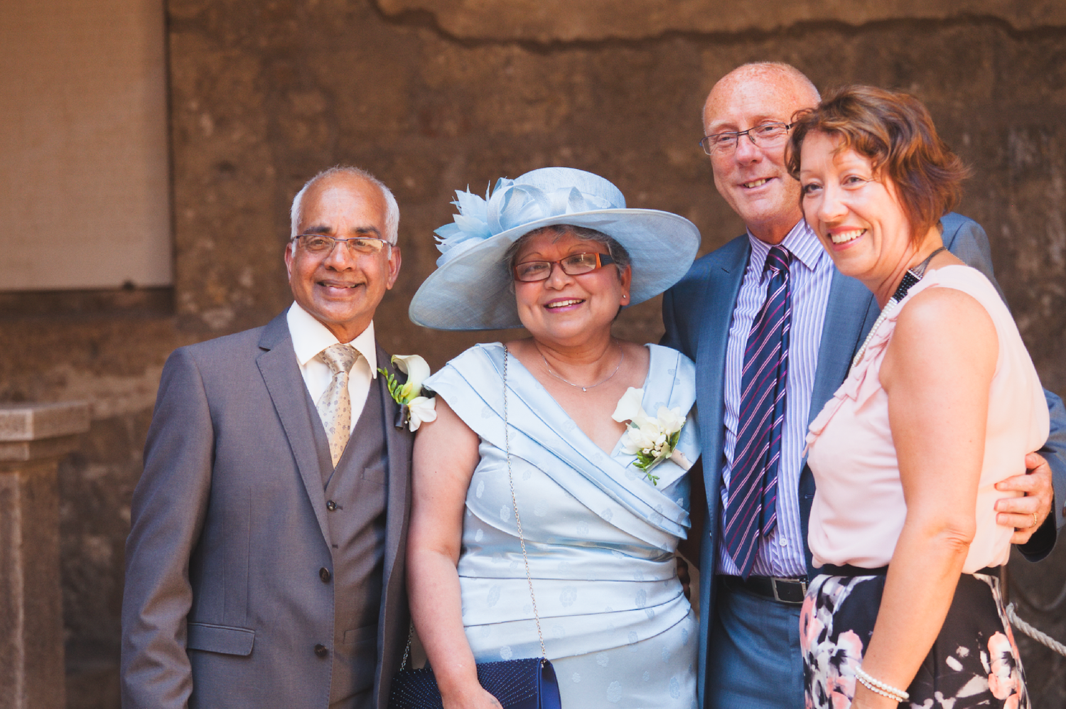 A small group poses together at a formal event wearing dressy attire.