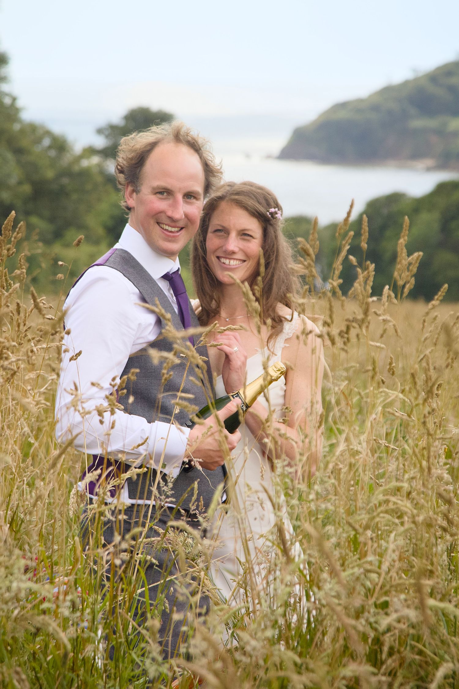 Coastal wedding photography shoot with a bride and groom during their beach wedding.