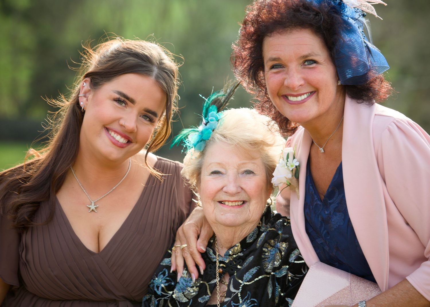 Group of wedding guests sharing joyful moments together outdoors.