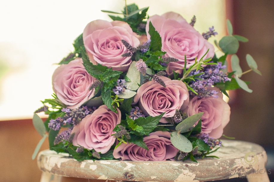 Boquet of roses on a stool taken udring a Pembrokeshire wedding by photographer Owen Lucas