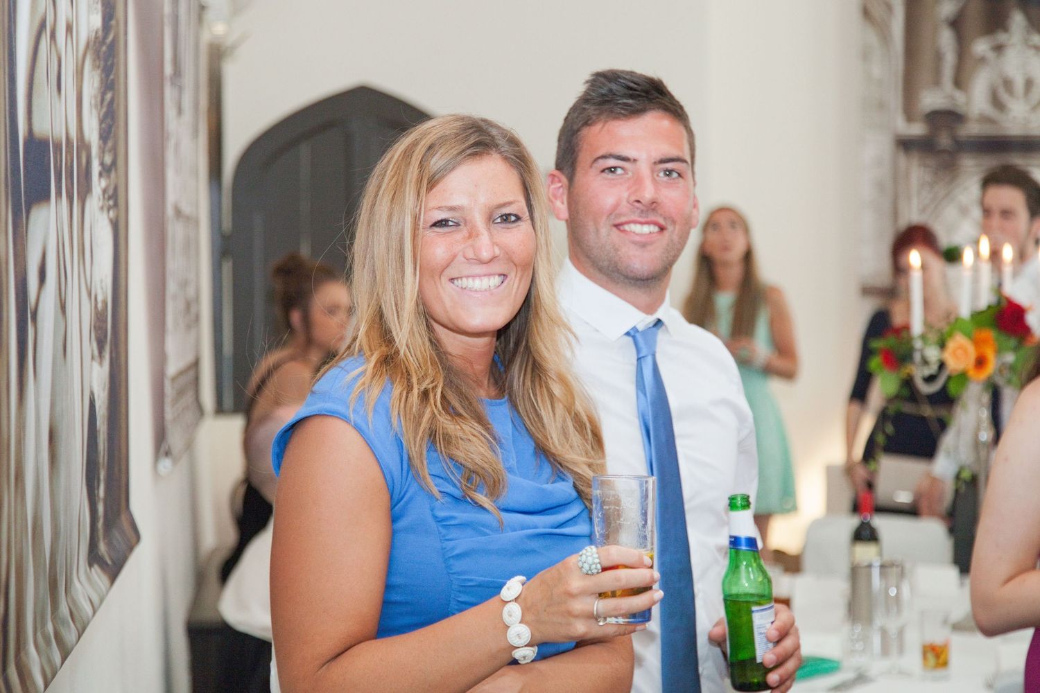 Guests mingling and enjoying drinks at an elegant indoor celebration.