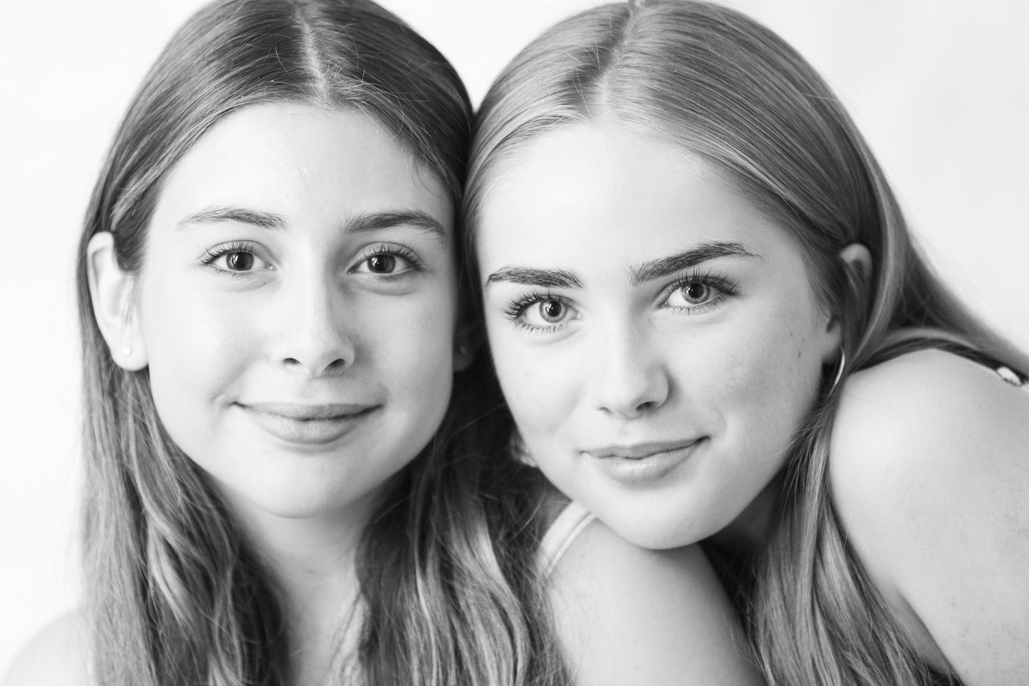 A black and white photo series showing the same person's facial expressions changing from serious to joyful.