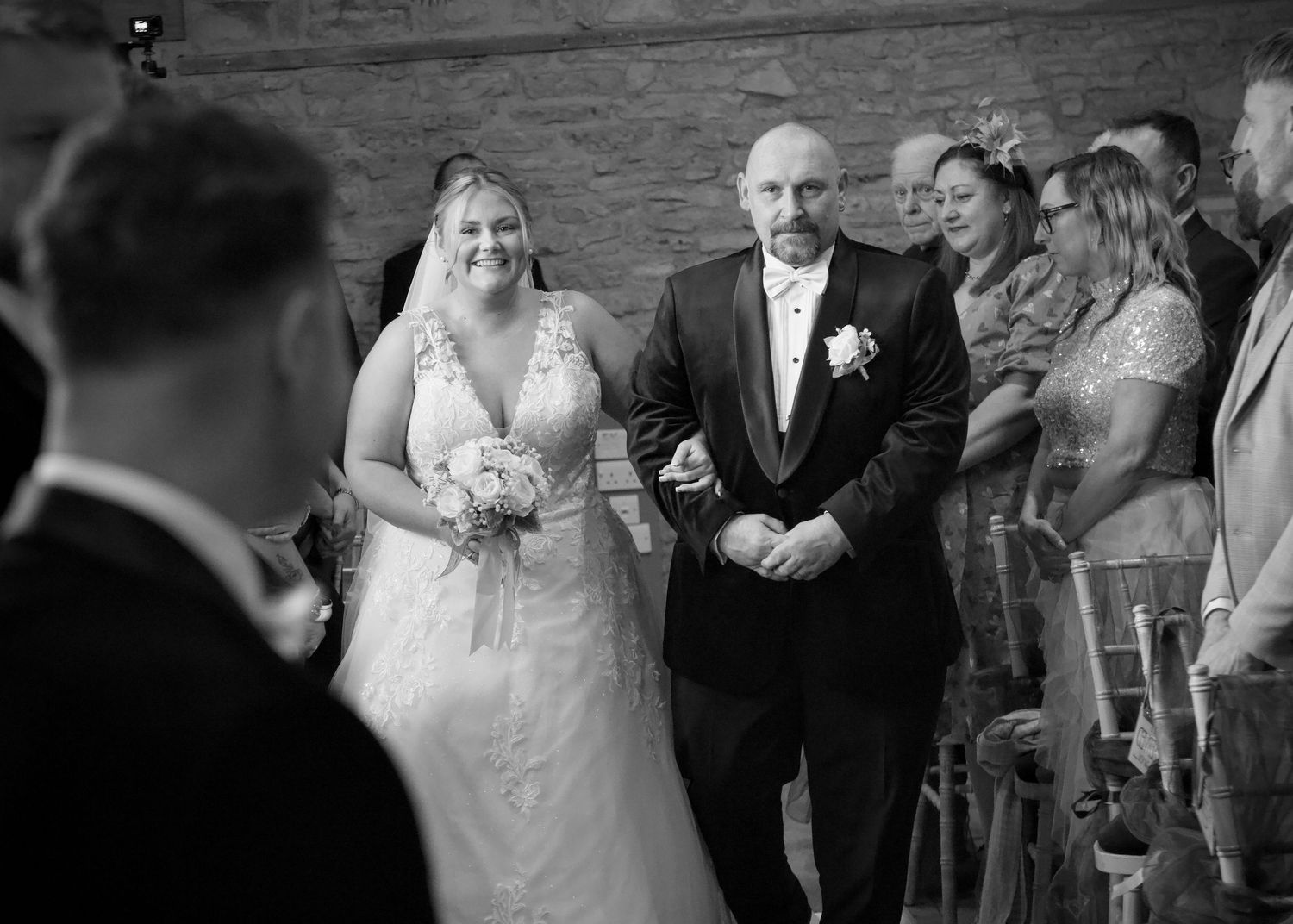 Black and white wedding ceremony candids with guests in attendance.