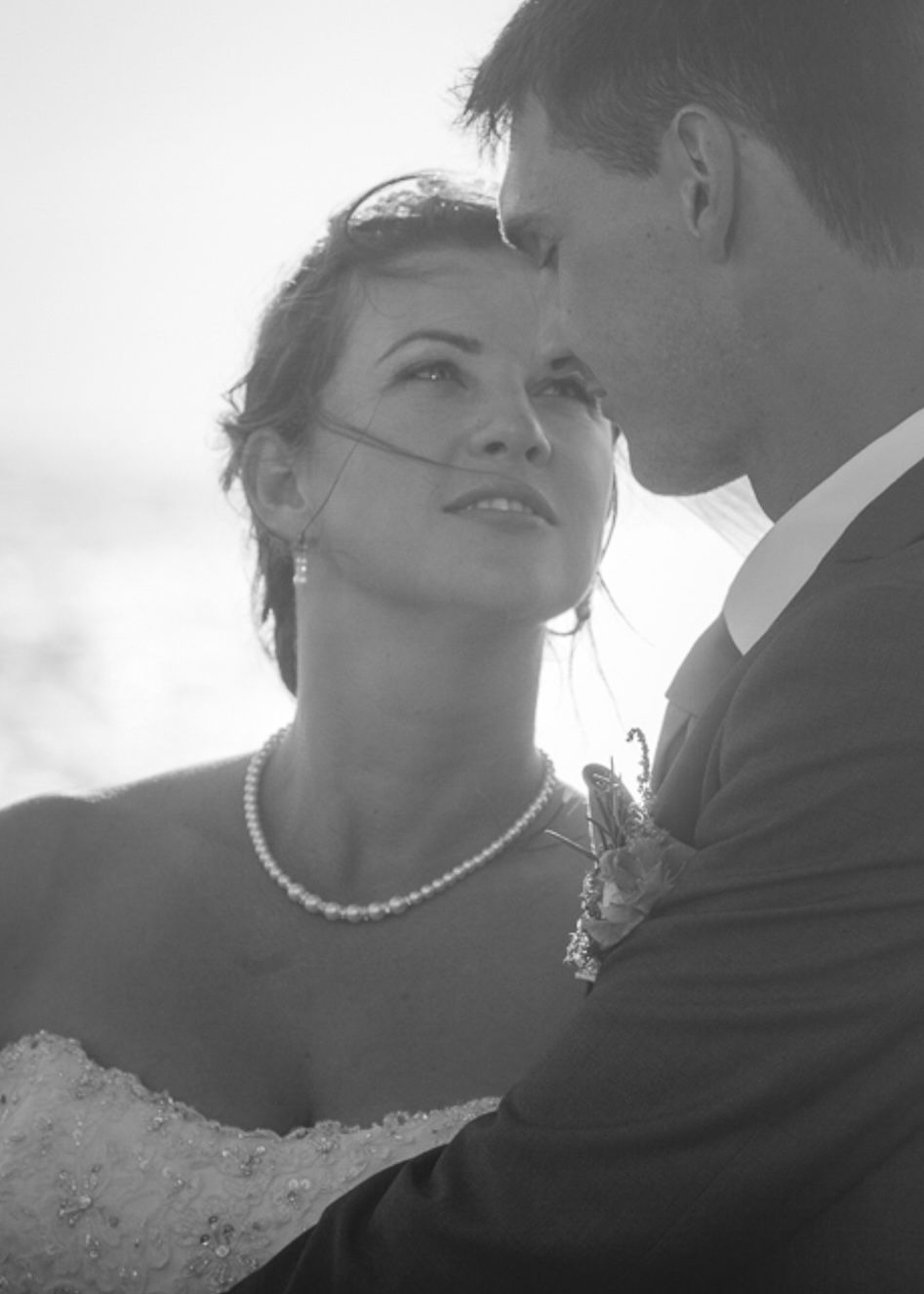 A romantic black and white close-up portrait of newlyweds.