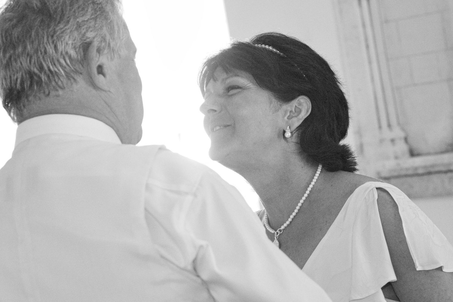 Wedding guests dancing in black and white formal attire at an elegant reception.