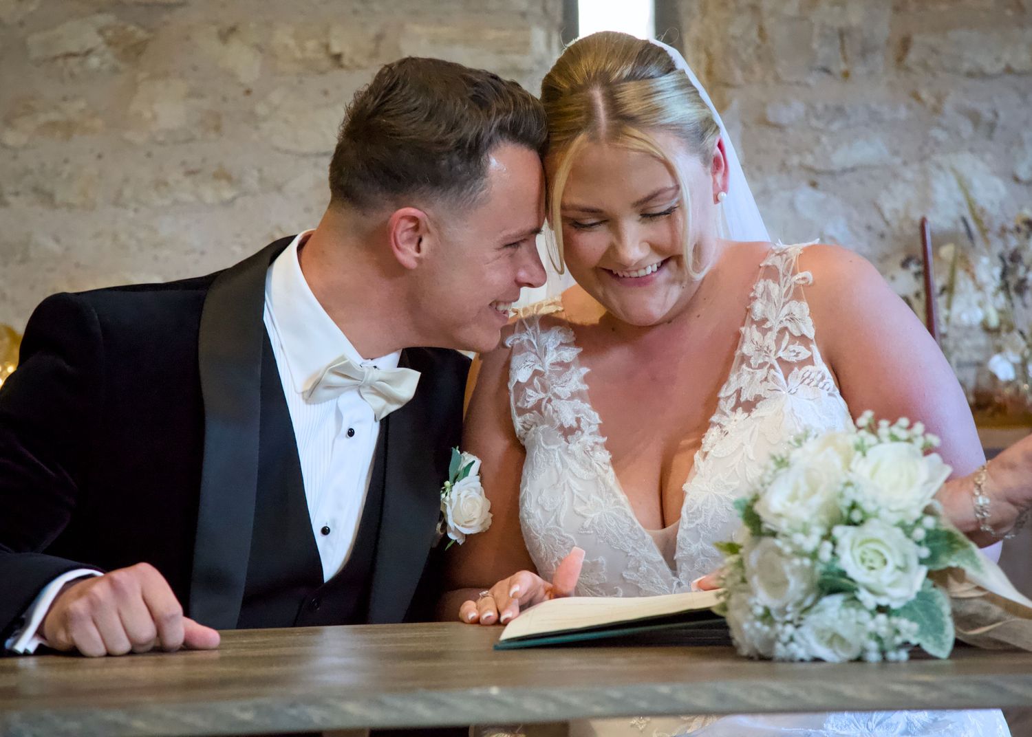 A tender moment between bride and groom as they share a quiet moment at their wedding at Folly Farm Somerset wedding